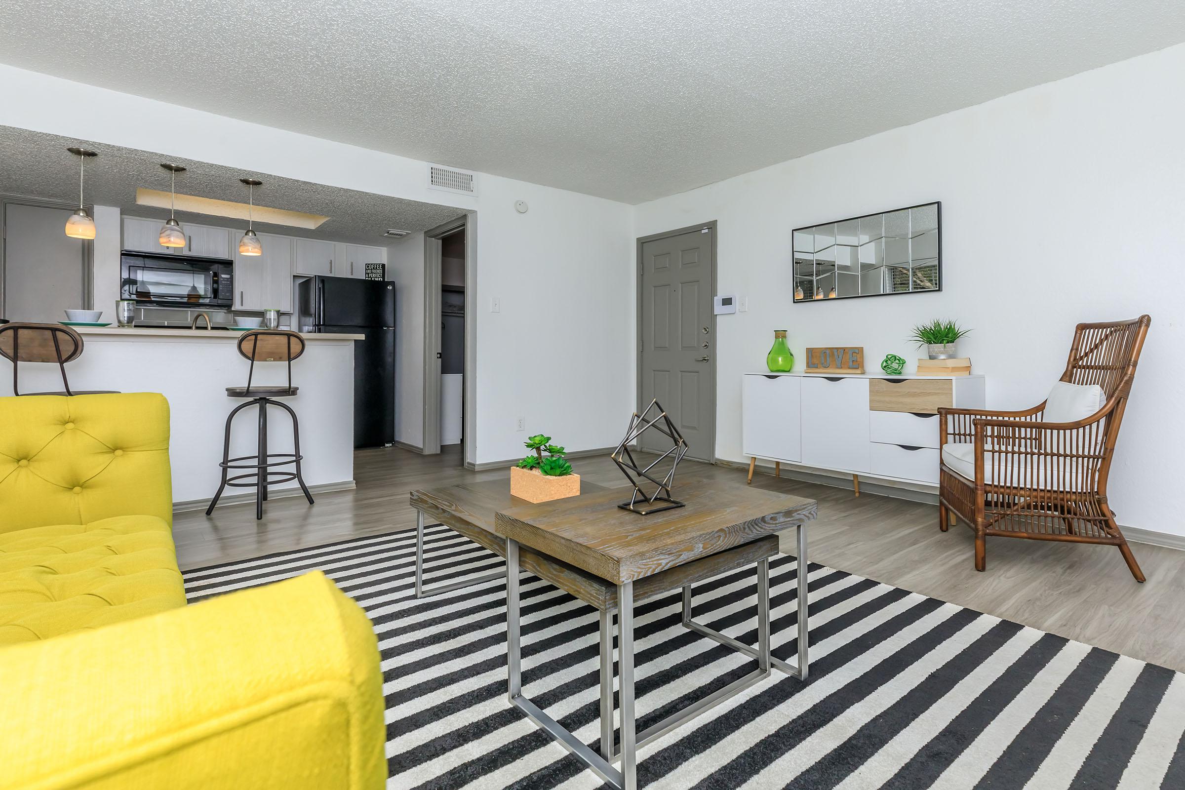 a living room filled with furniture and a table