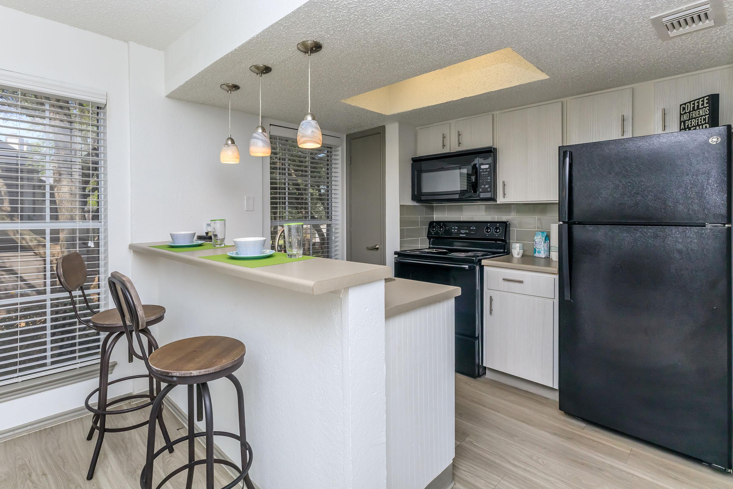 WELL-LIT BREAKFAST BAR WITH LARGE KITCHEN PANTRY