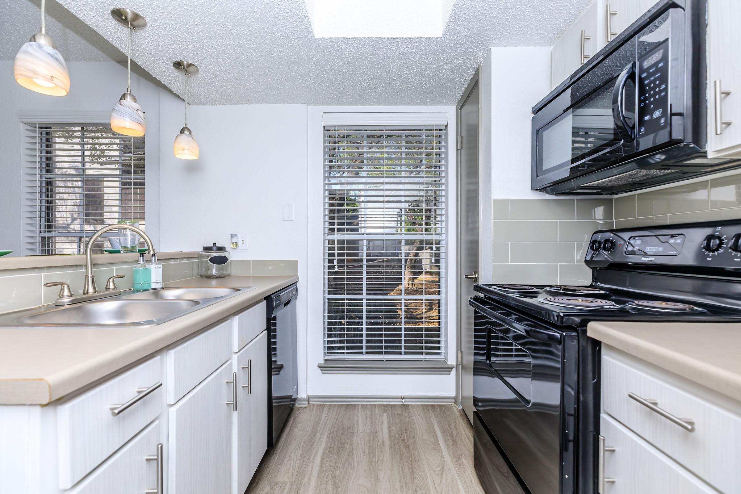 a stove top oven sitting inside of a kitchen