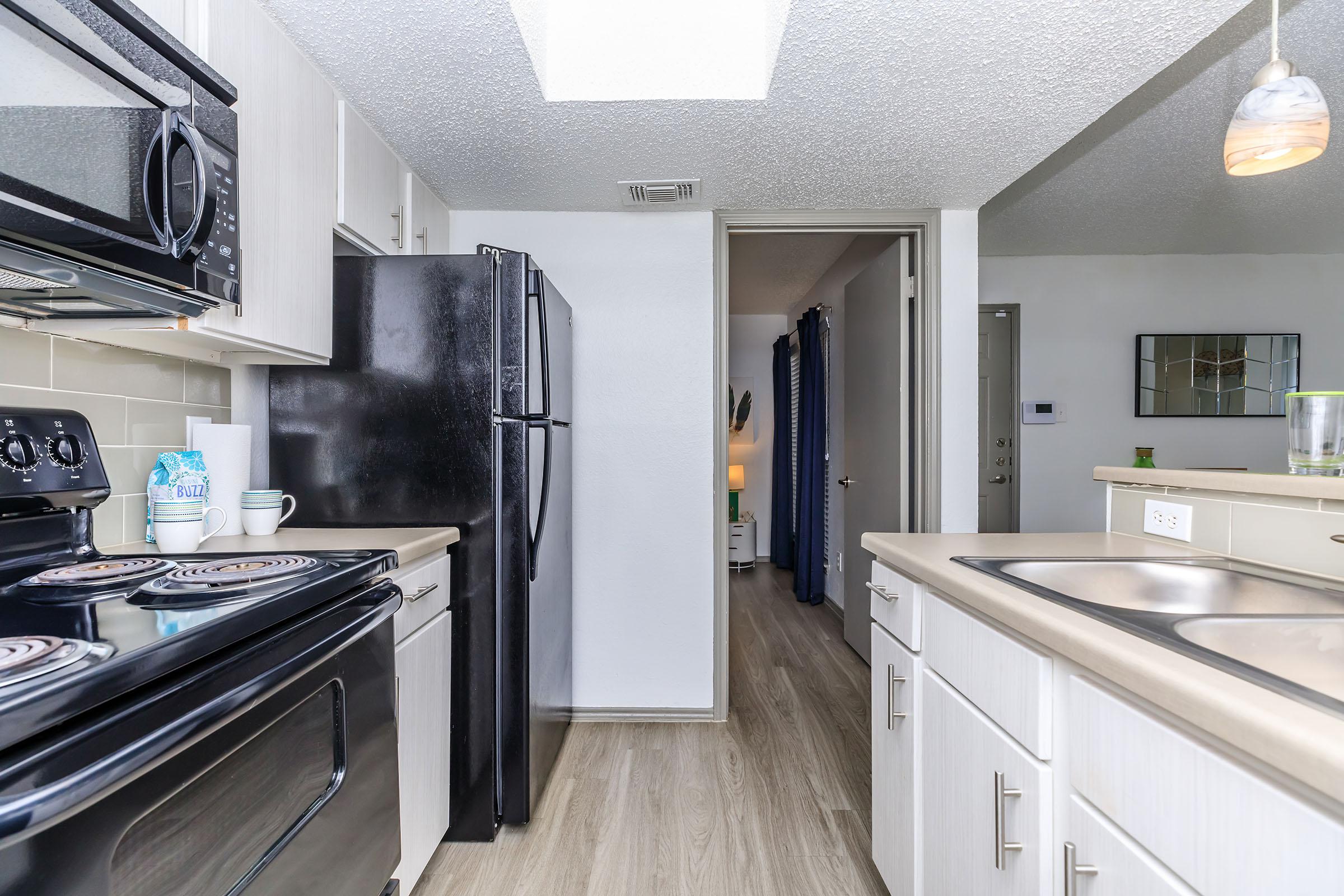 a stove top oven sitting inside of a kitchen