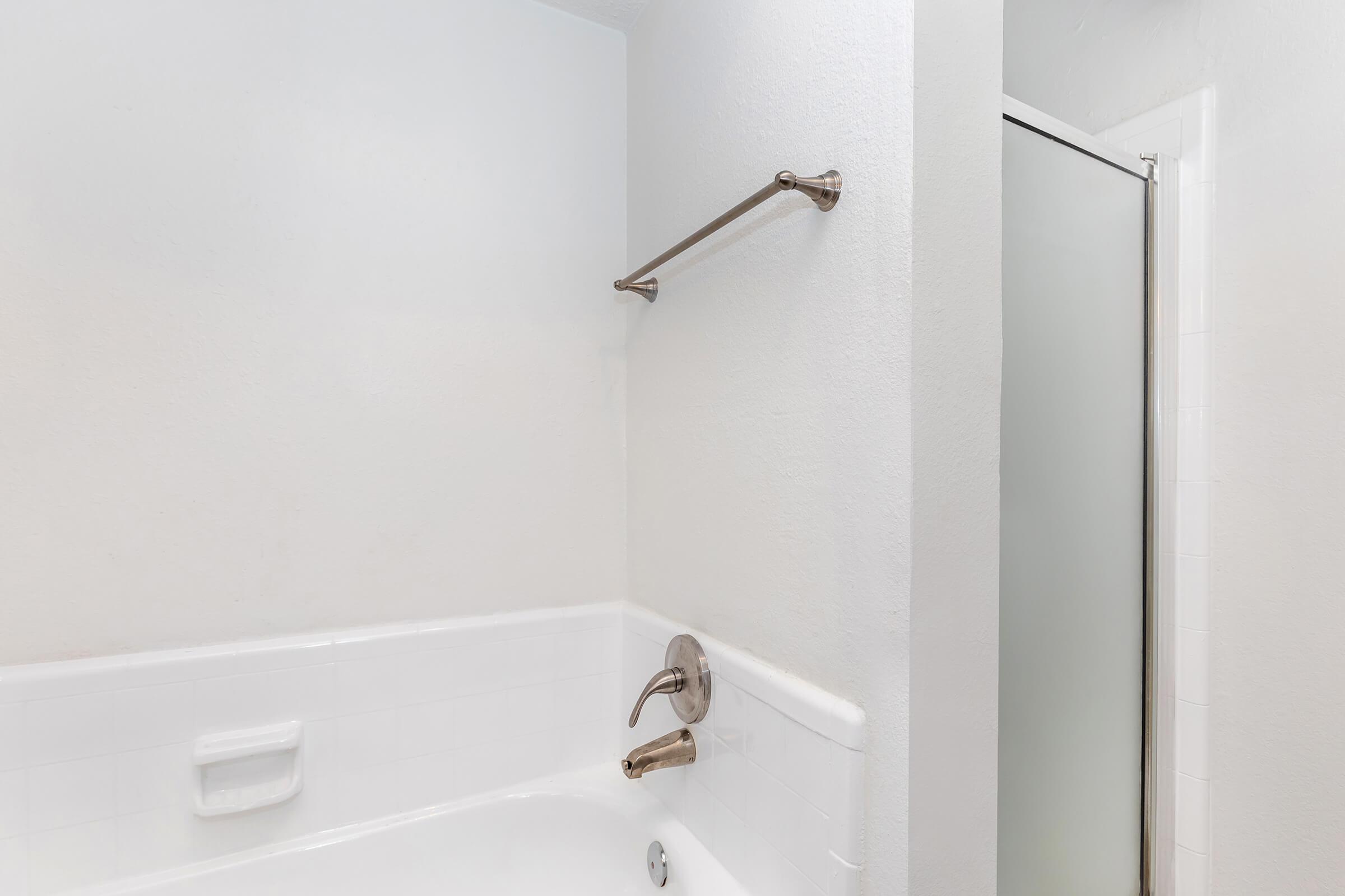 a white sink sitting next to a shower