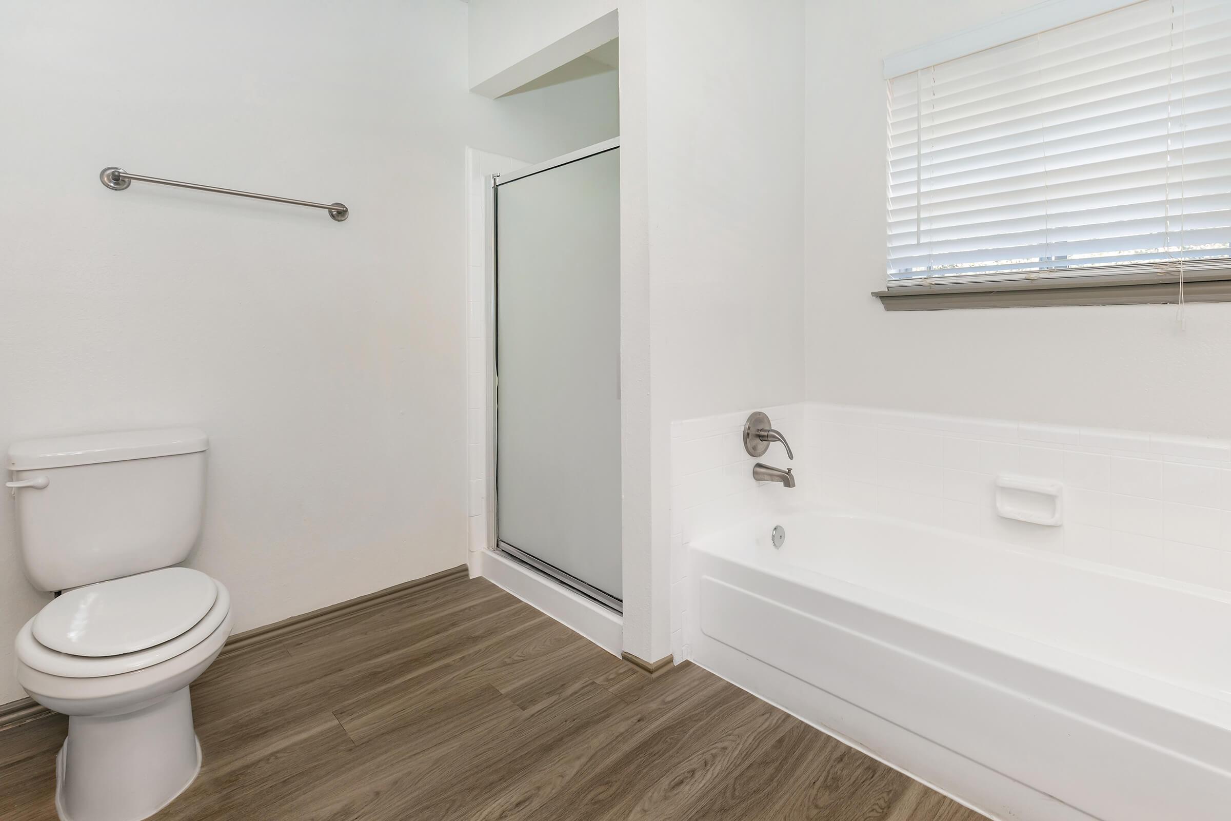 a white tub sitting next to a window