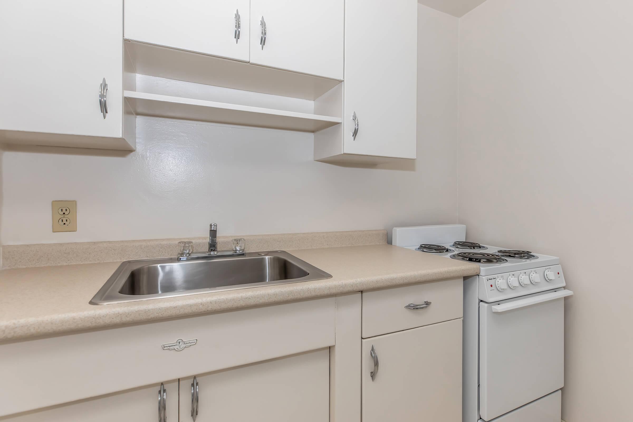 a kitchen with a sink and a mirror