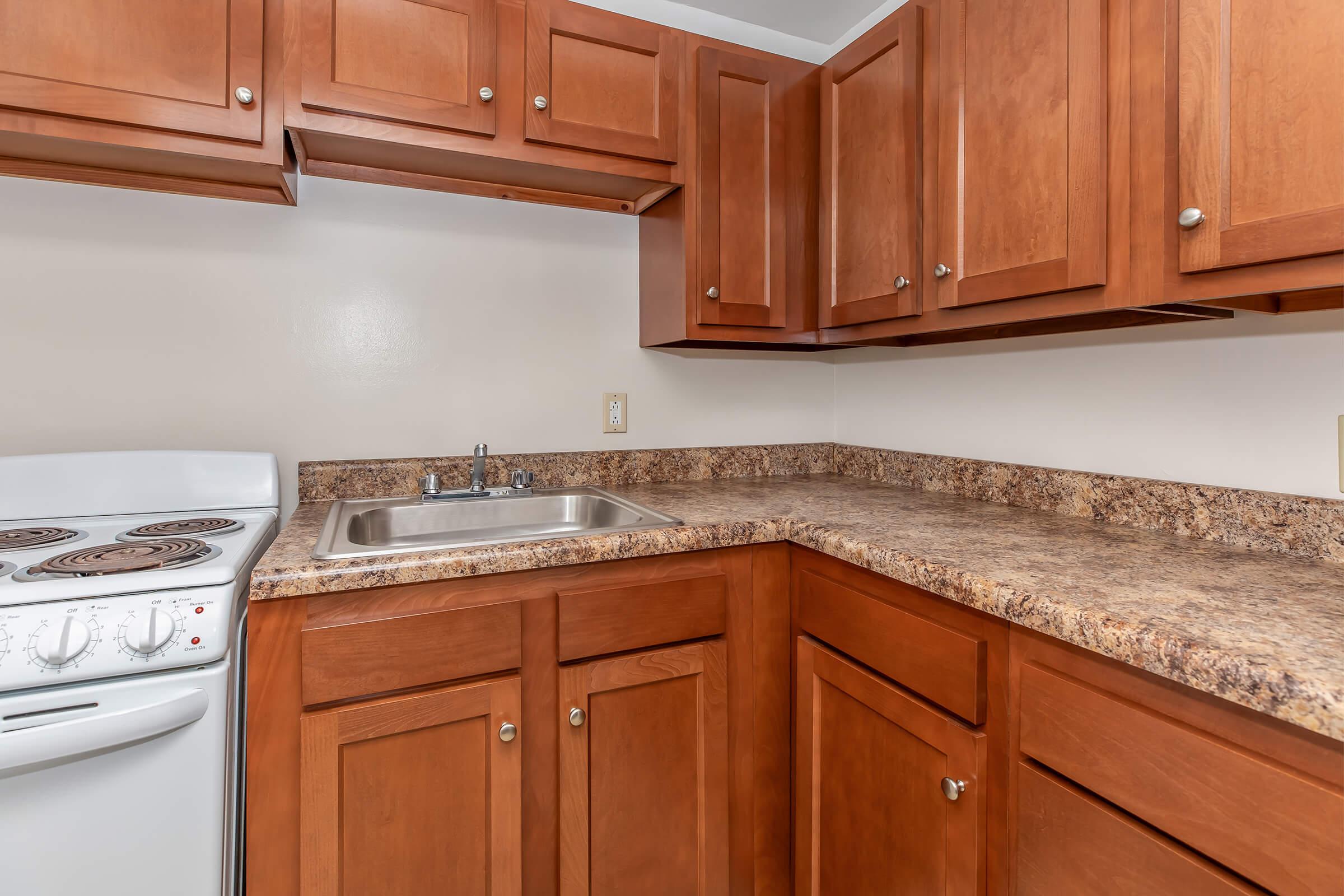 a kitchen with a stove a sink and a microwave