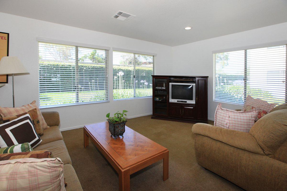 a living room filled with furniture and a flat screen tv