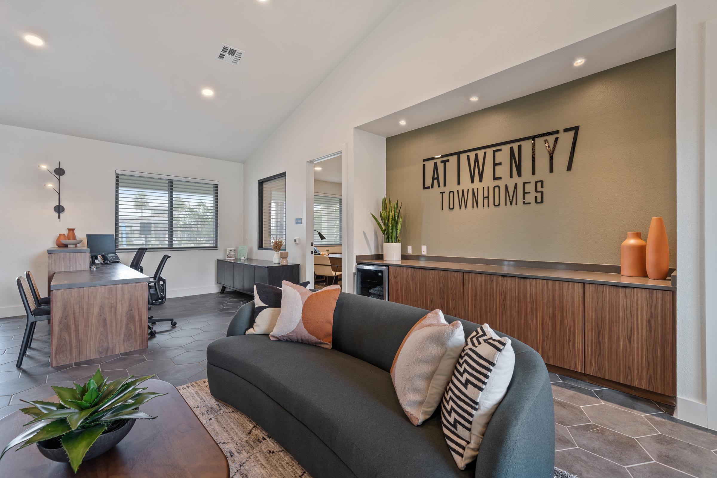 a living room filled with furniture and a large window