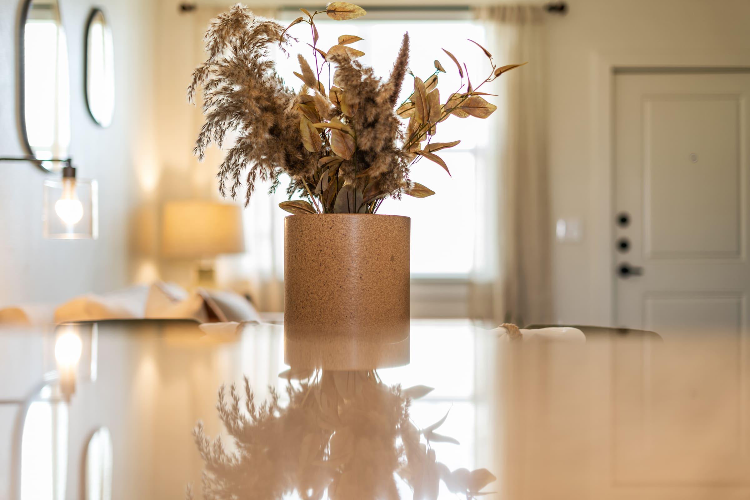 a vase of flowers on a kitchen counter