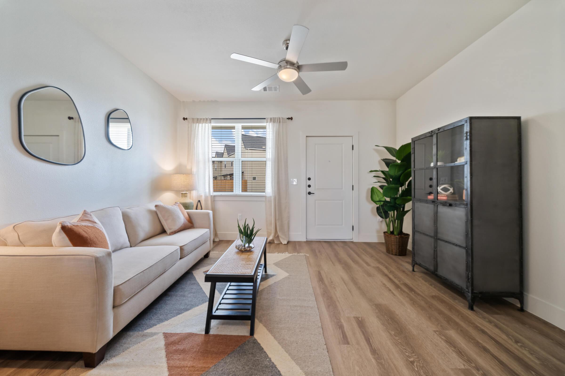 a living room filled with furniture and a large window