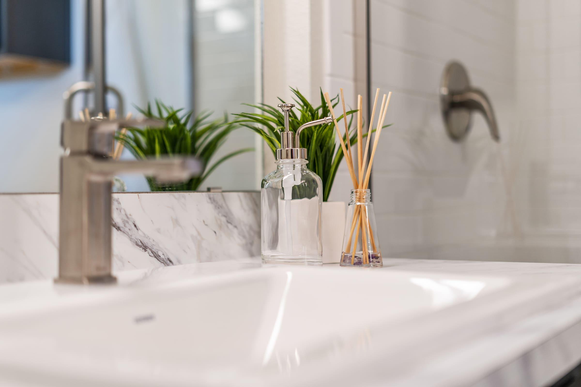 a vase of flowers on a table next to a sink