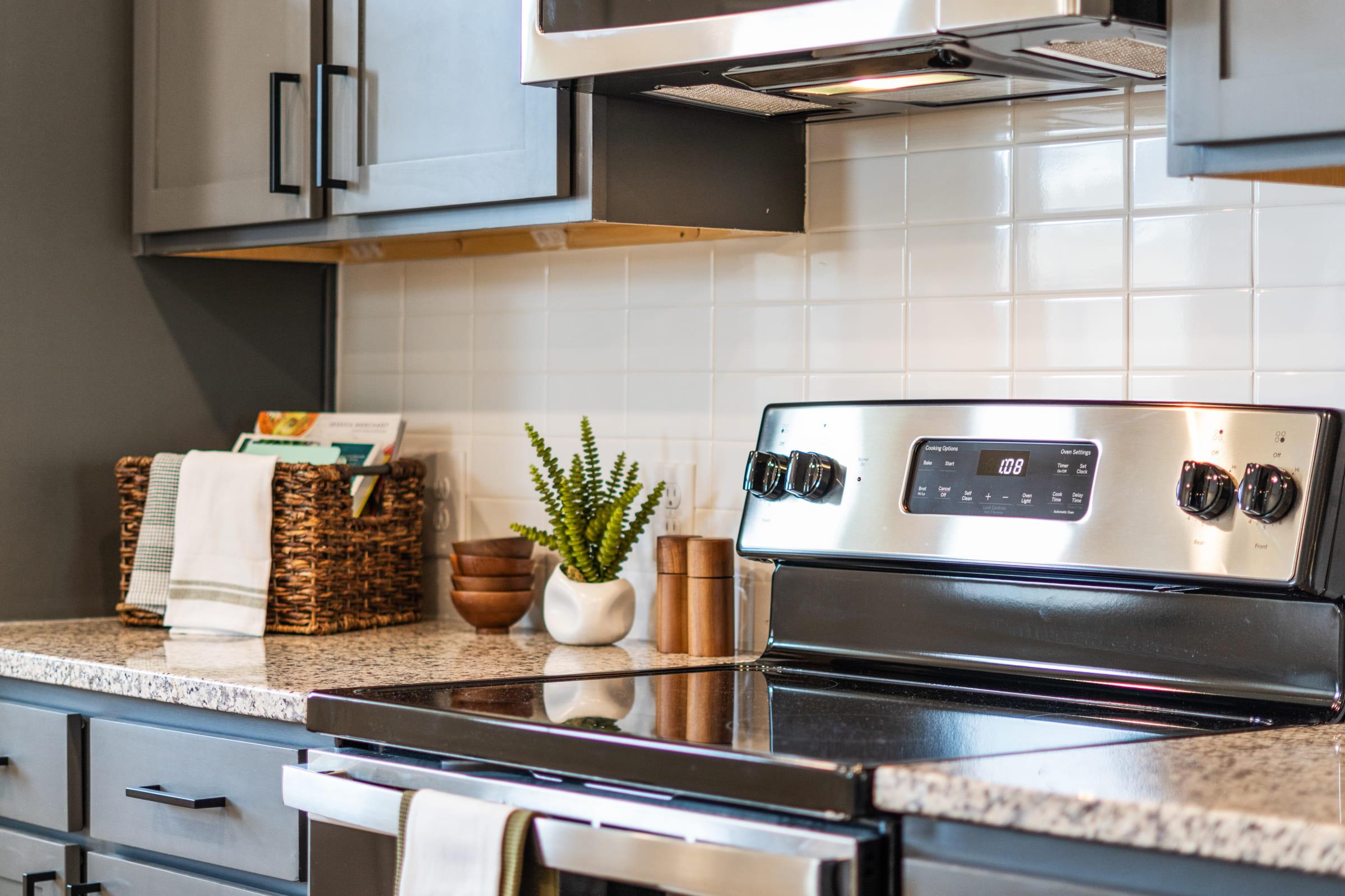 a stove top oven sitting inside of a kitchen