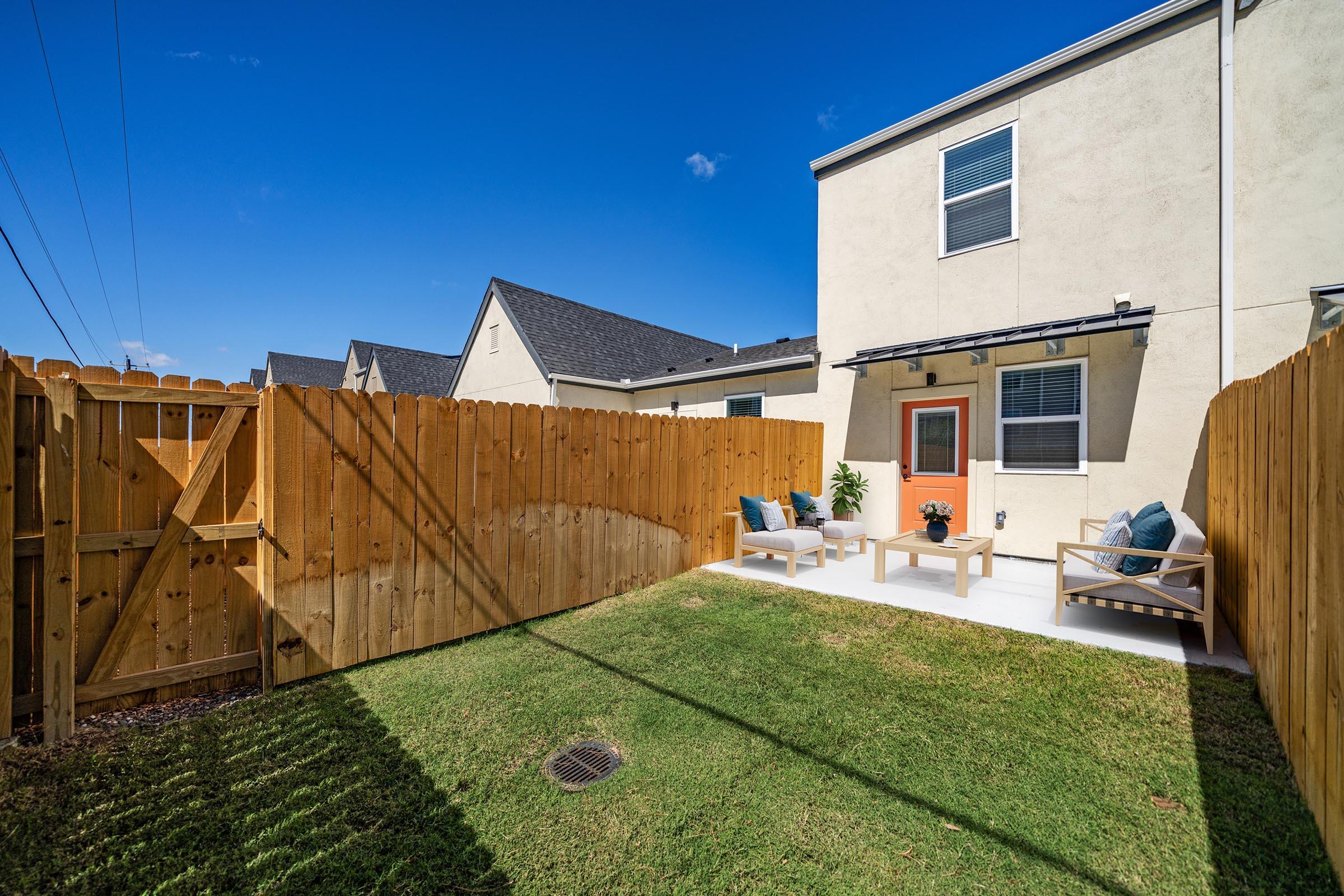 a yard with grass and a building