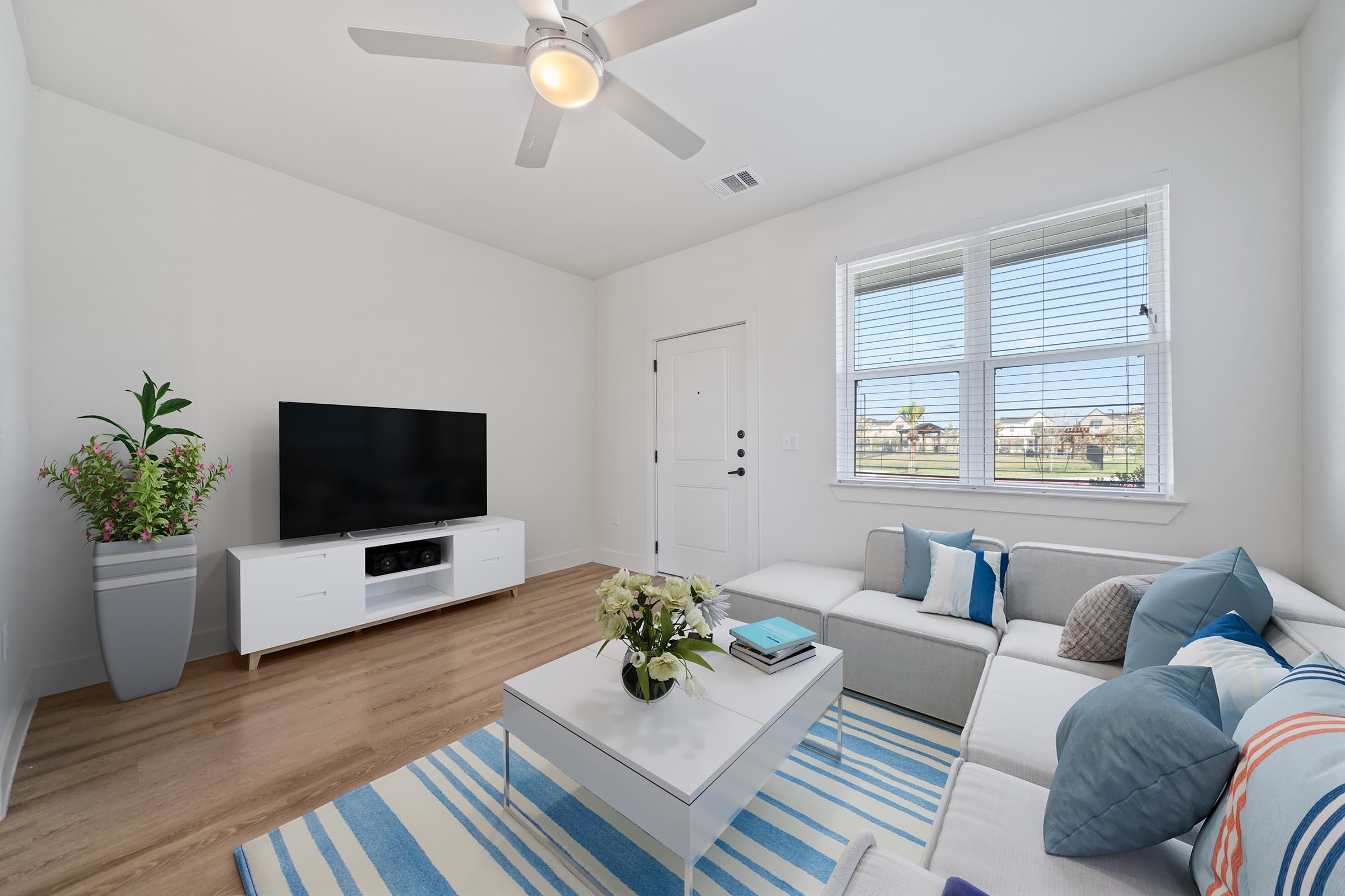 a living room filled with furniture and a large window