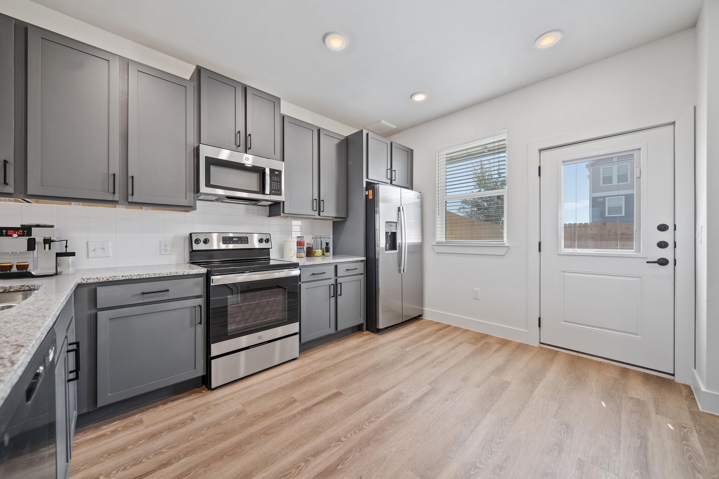 a large kitchen with stainless steel appliances