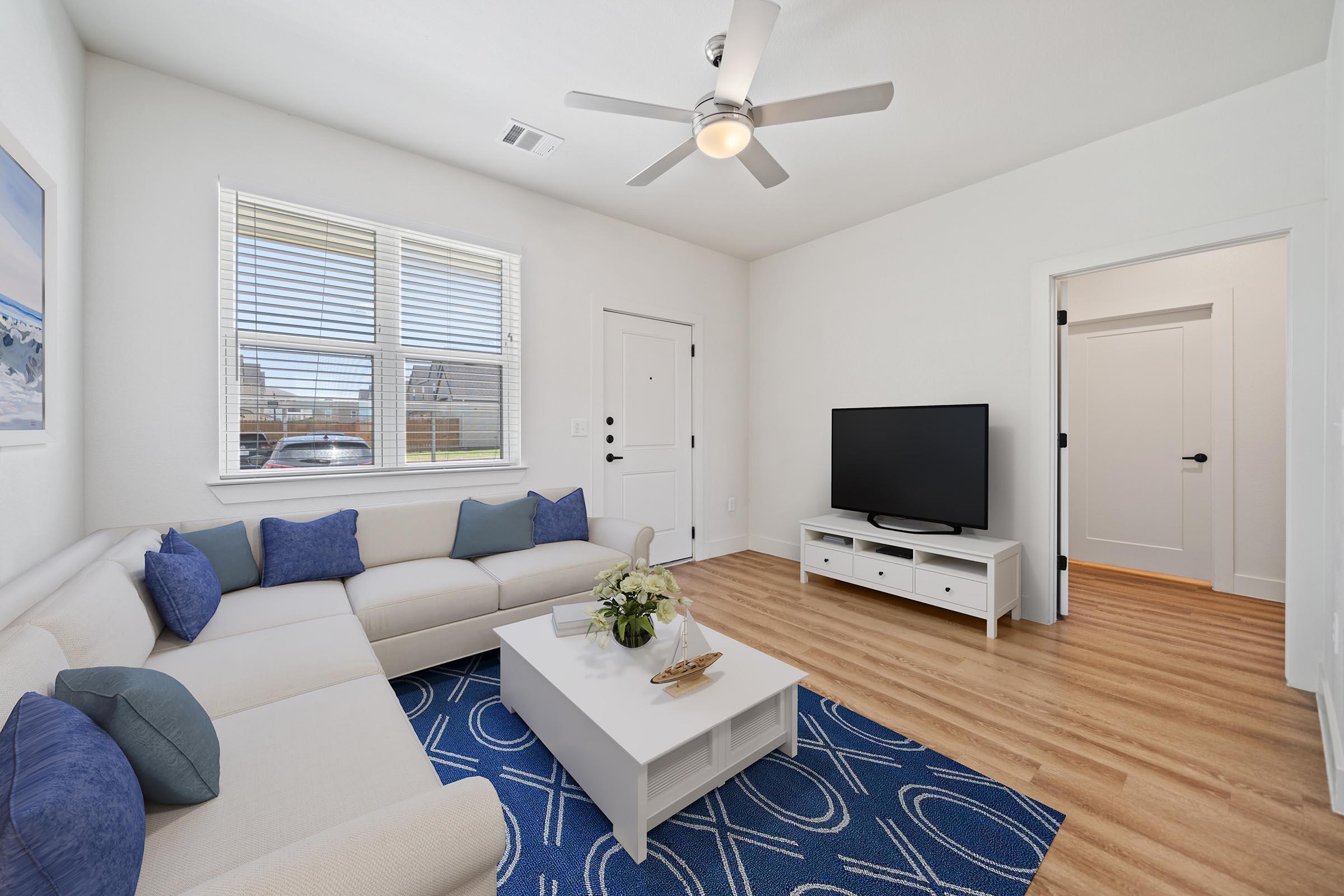 a living room filled with furniture and a flat screen tv