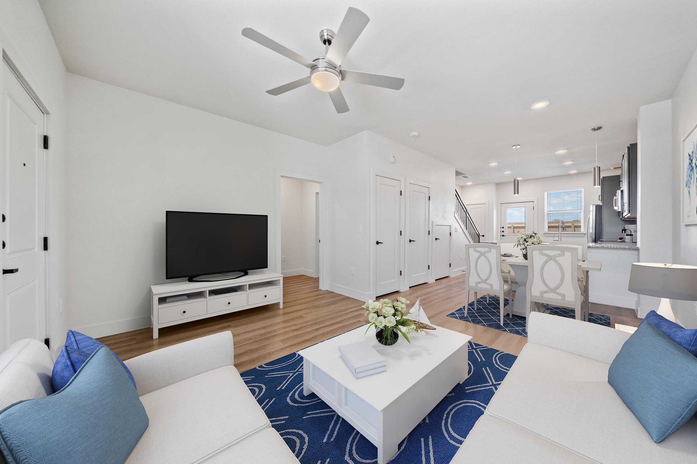 a living room filled with furniture and a flat screen tv