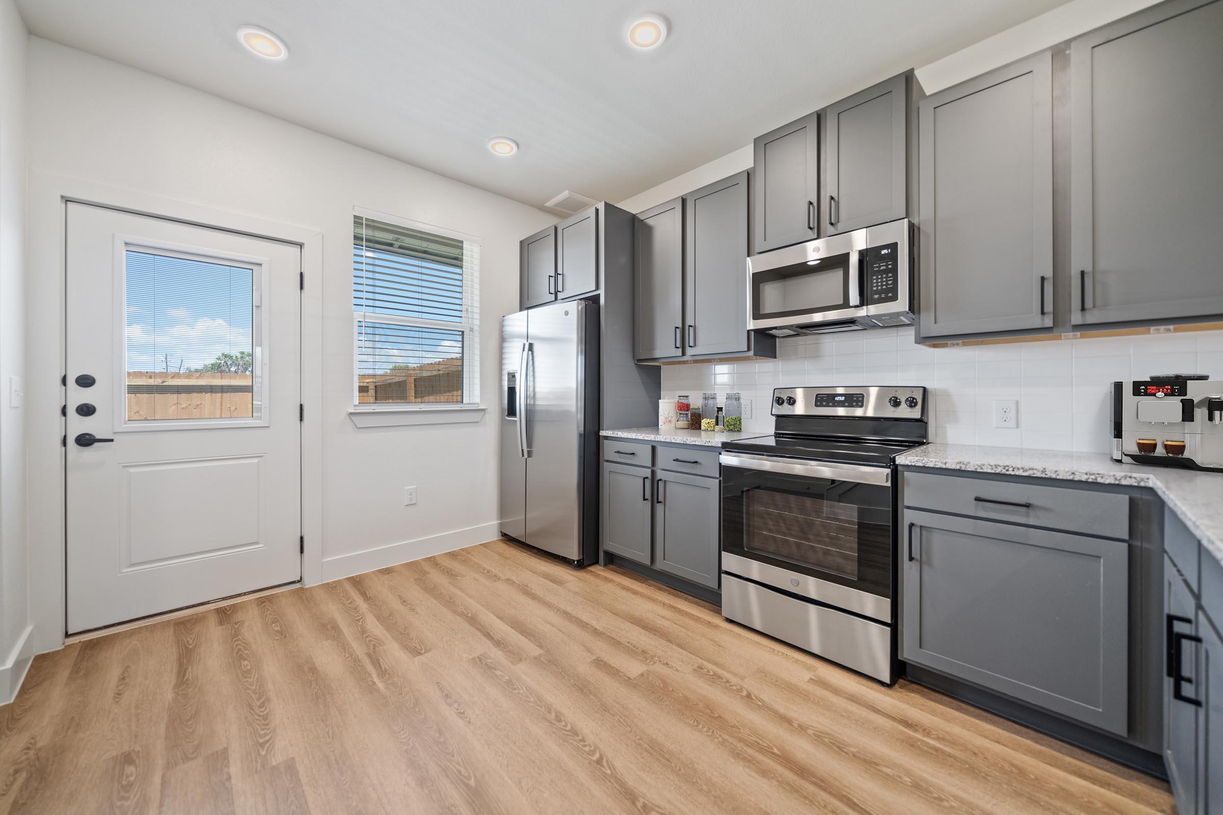 a large kitchen with stainless steel appliances