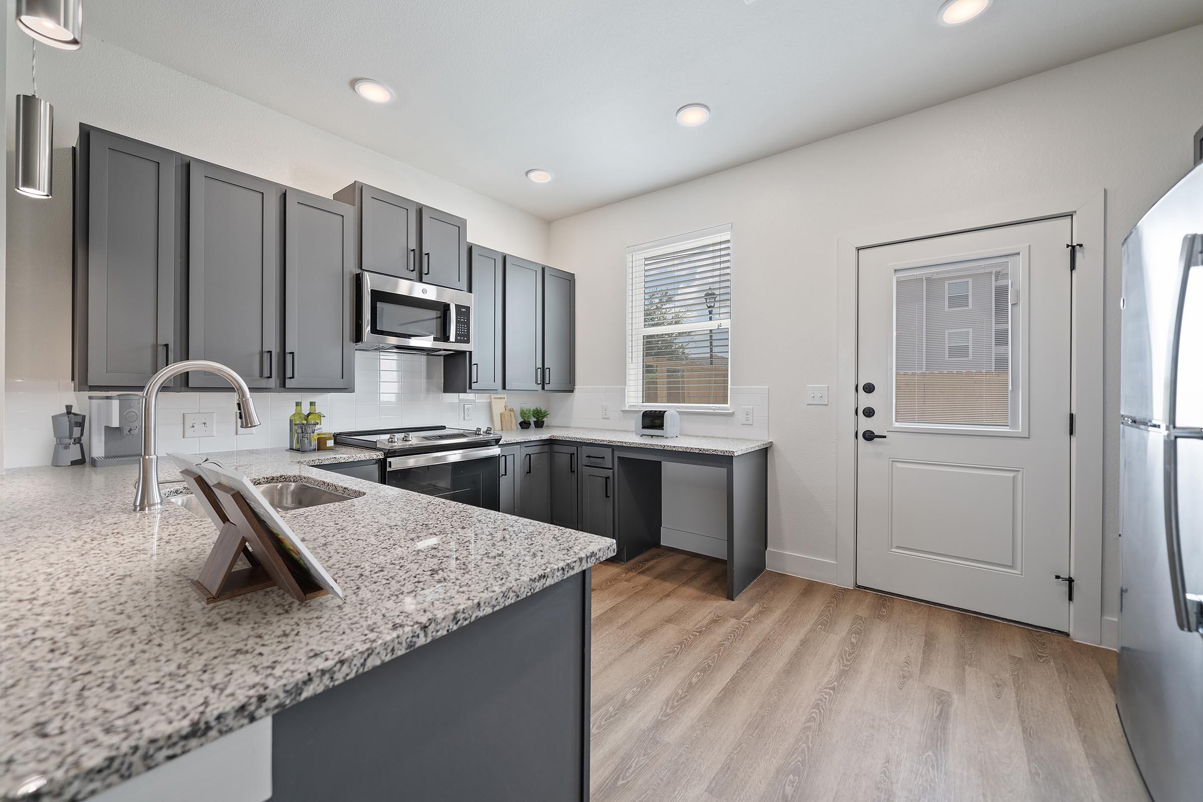 a kitchen with a sink and a mirror