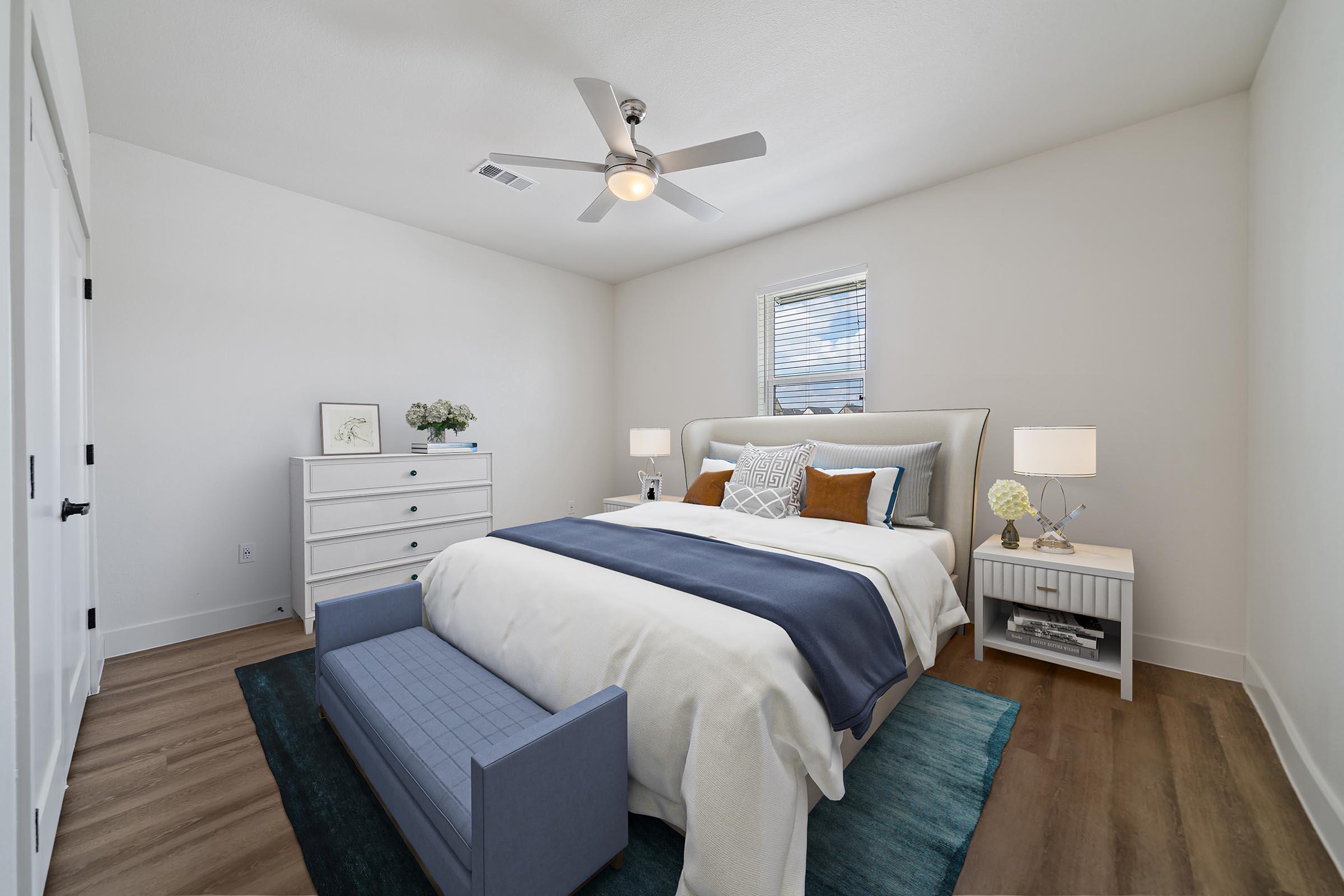 a bedroom with a bed and desk in a room