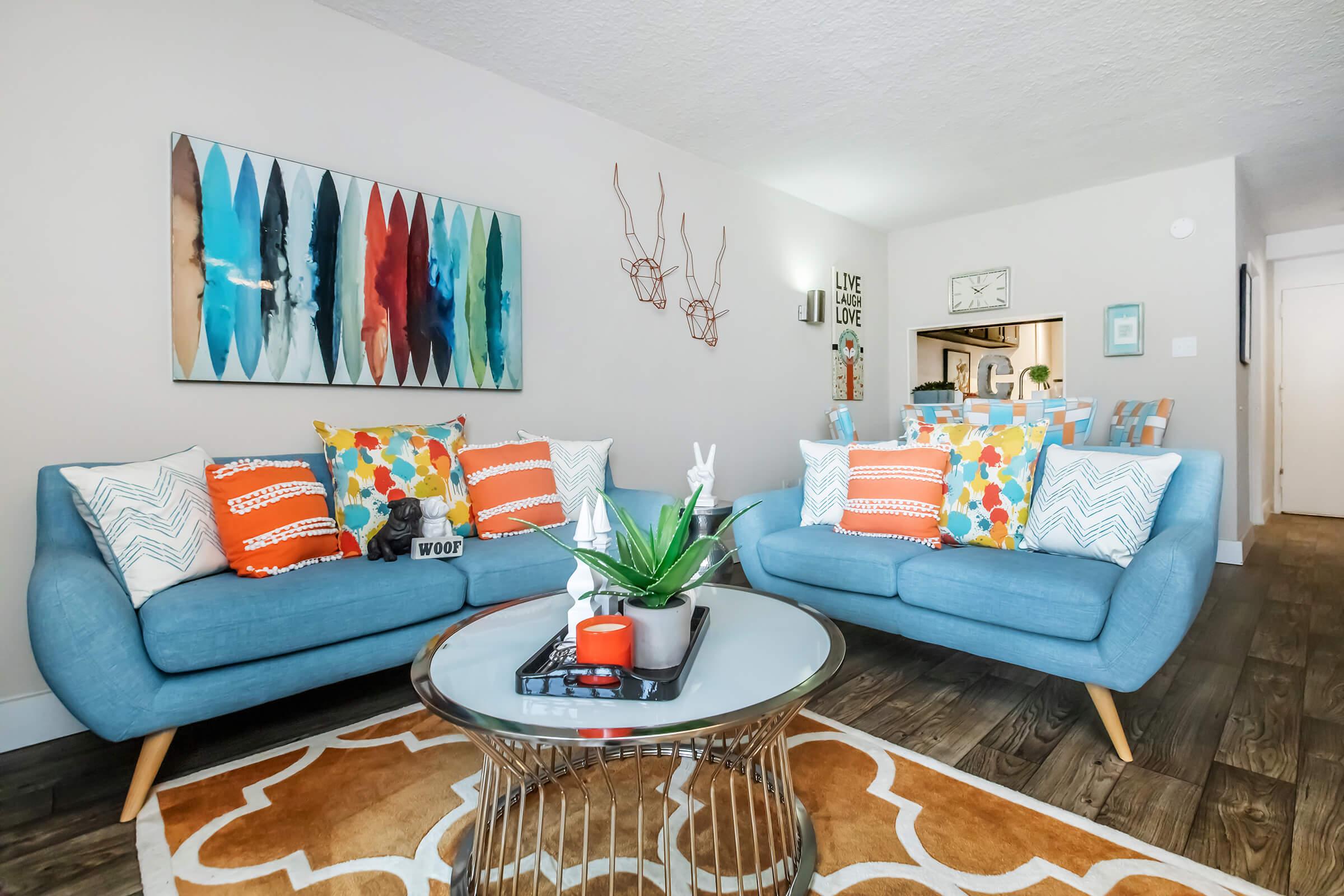 a living room filled with furniture and a flat screen tv