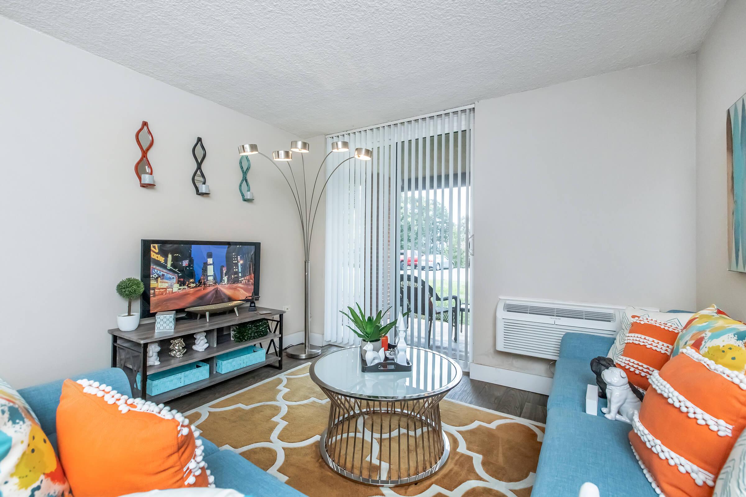 a bedroom with a bed and desk in a room