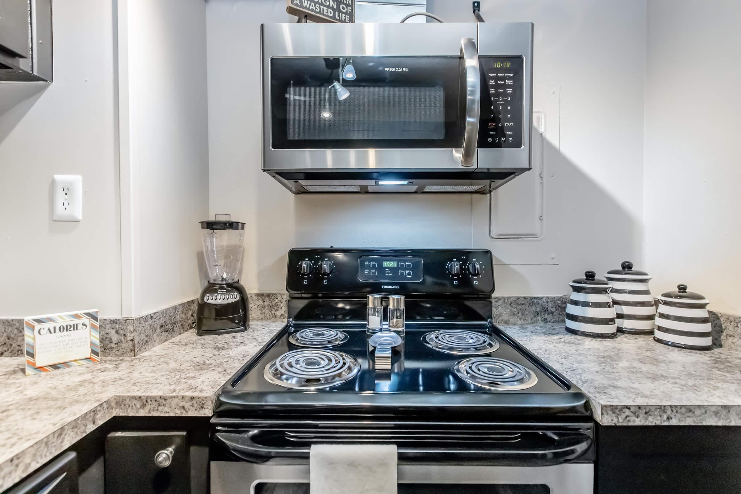 a stove top oven sitting inside of a kitchen counter