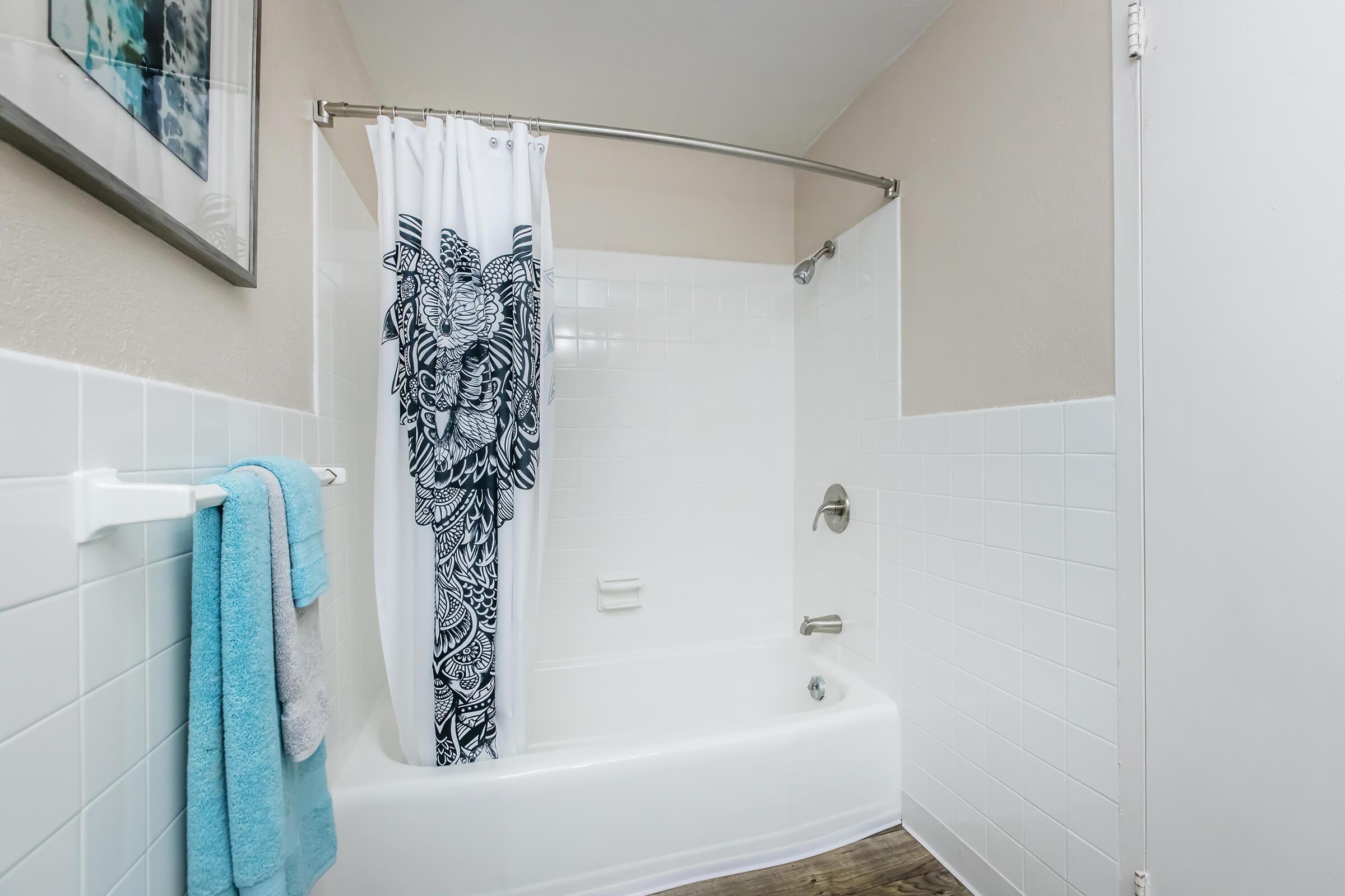 a shower curtain next to a sink