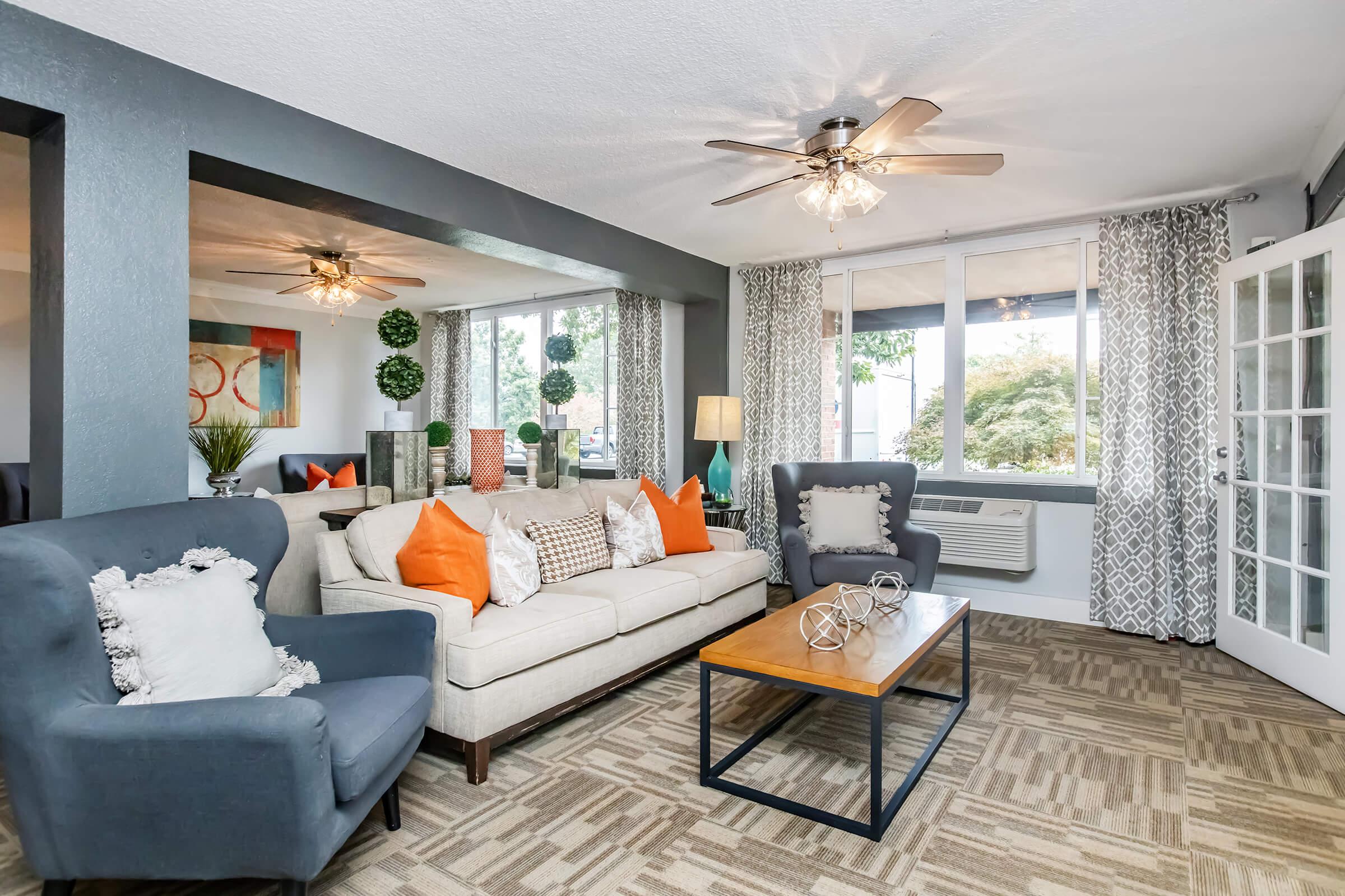 a living room filled with furniture and a large window