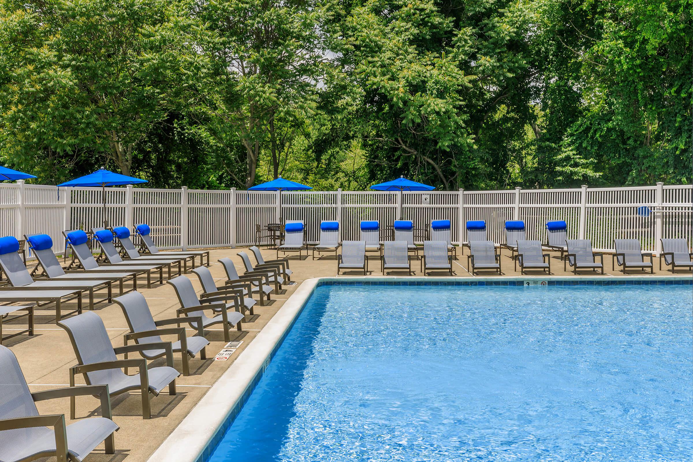 a blue bench next to a pool of water