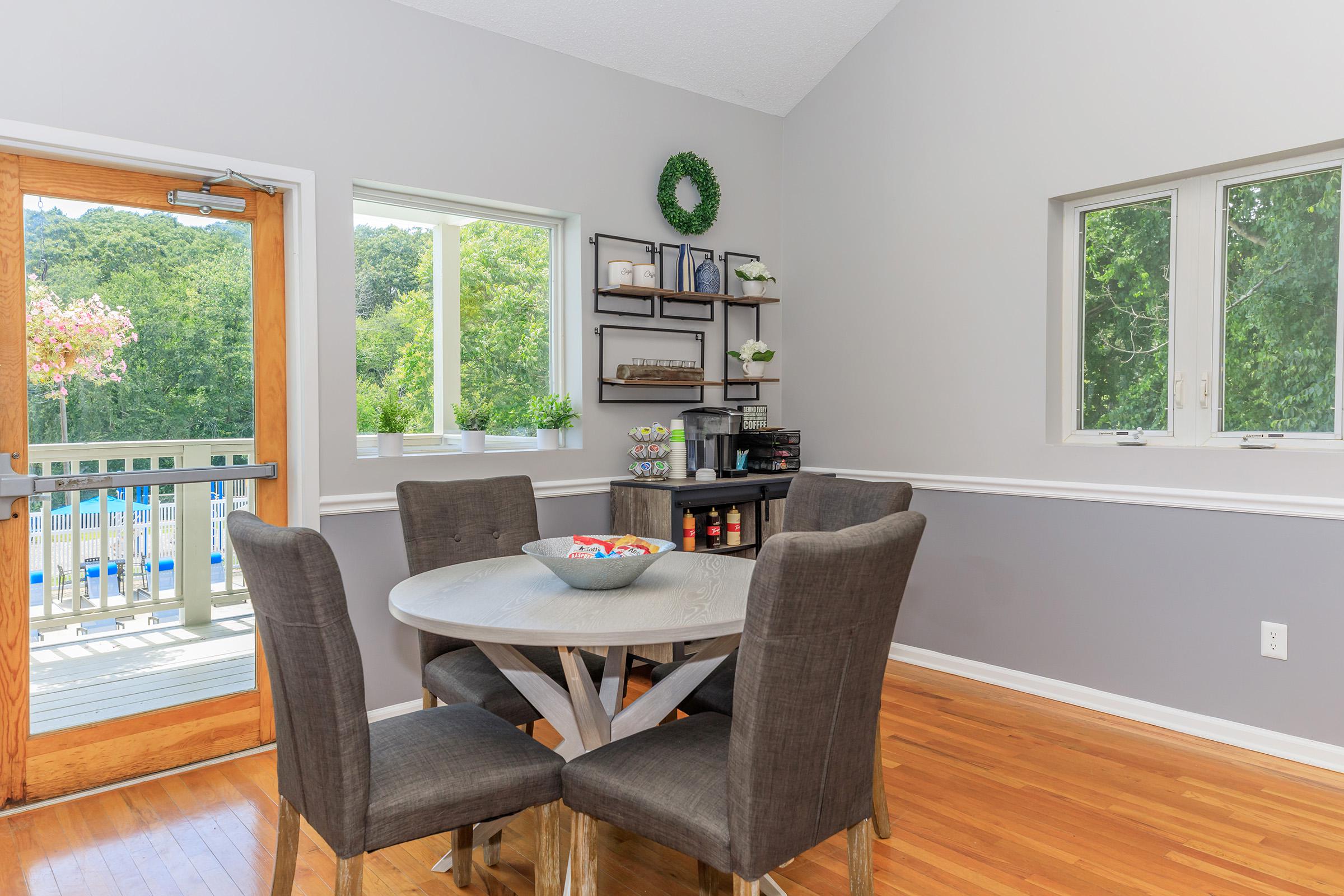 a living room filled with furniture and a large window