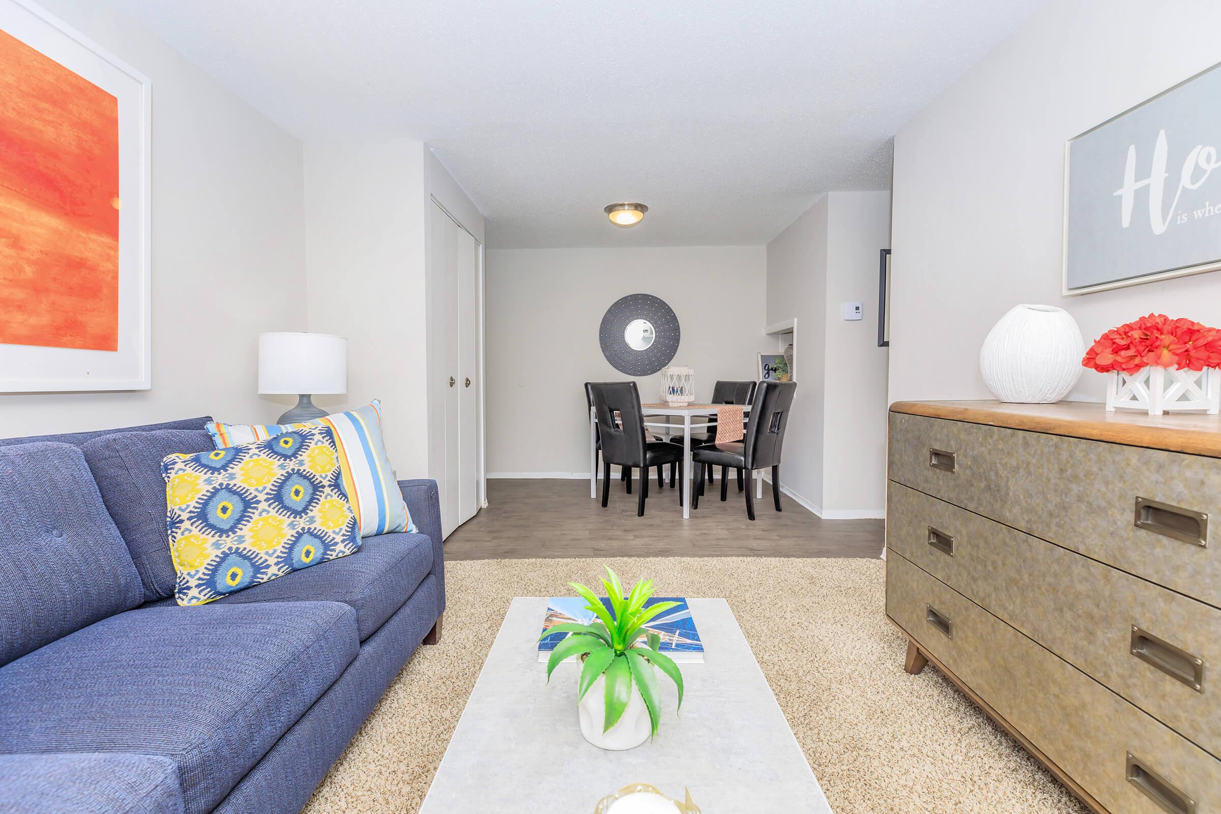 a bedroom with a bed and a couch in a living room