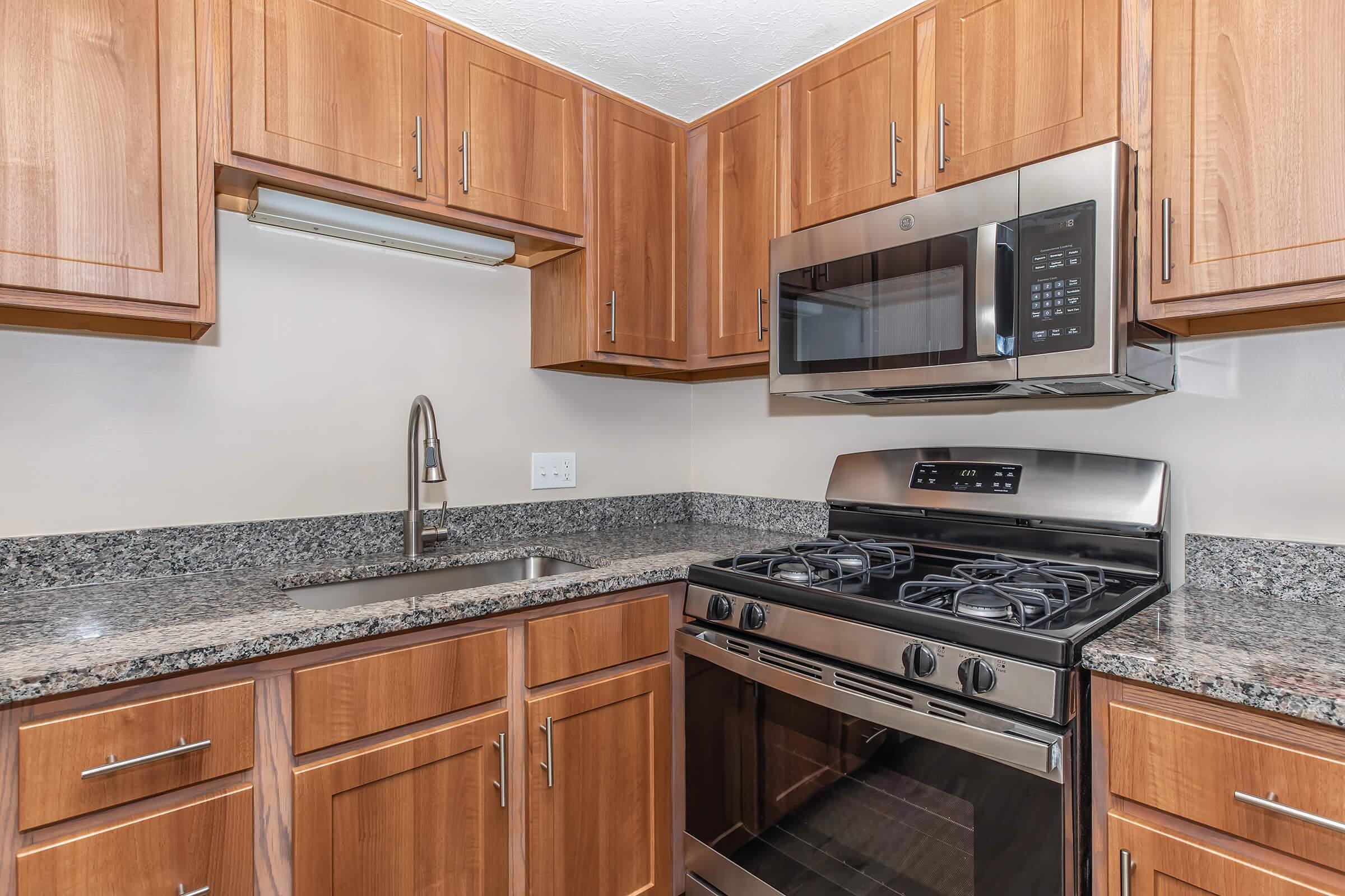 a kitchen with stainless steel appliances and wooden cabinets