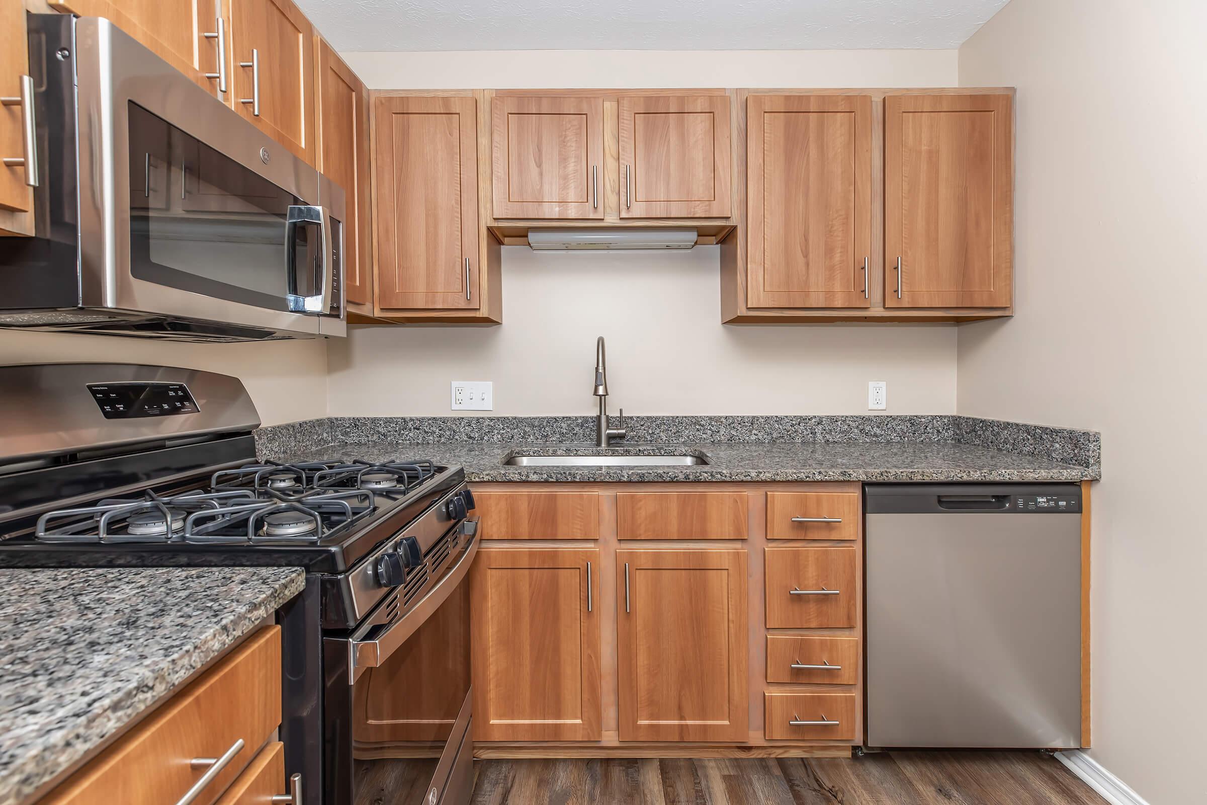 a kitchen with stainless steel appliances and wooden cabinets