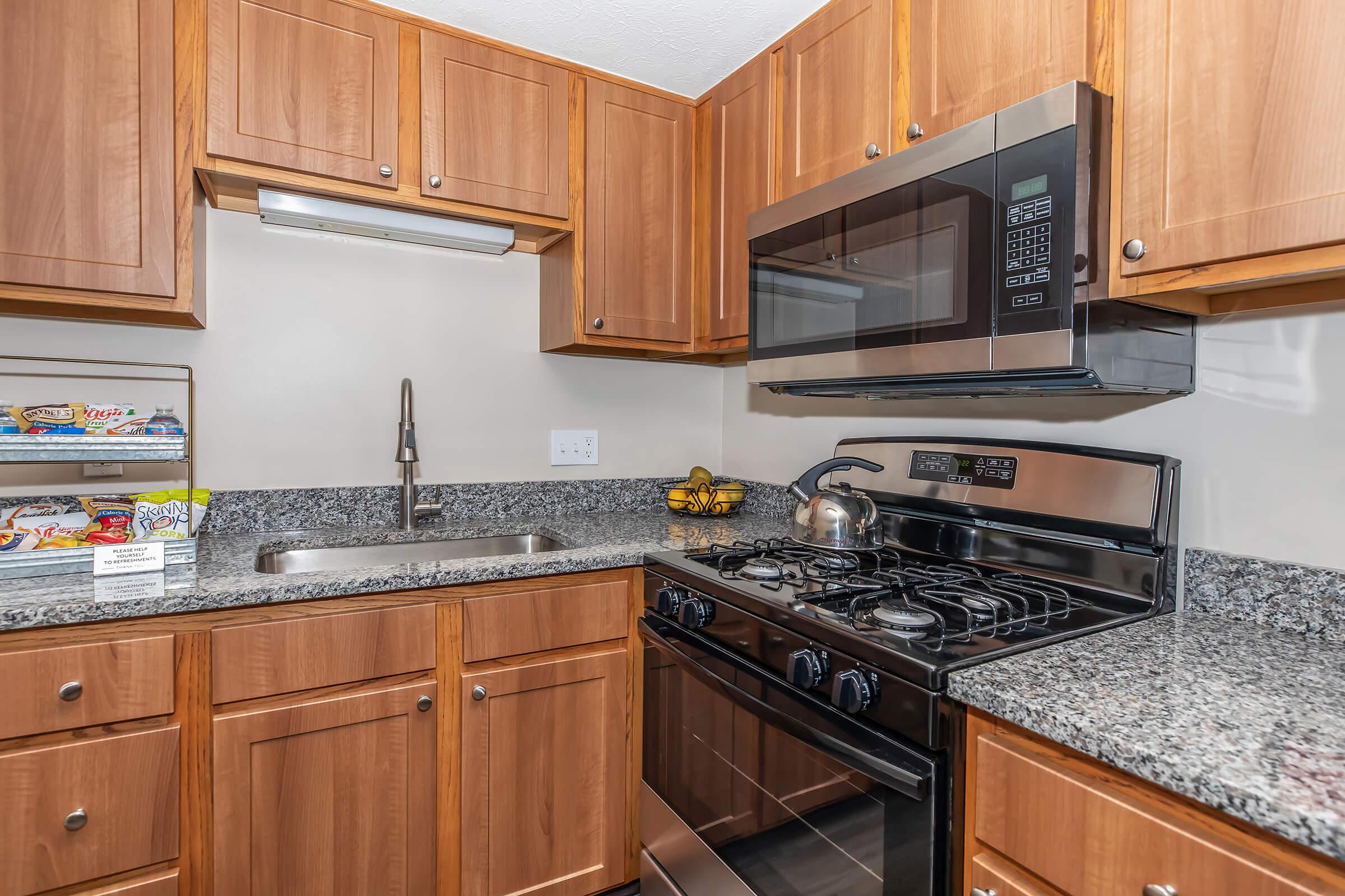 a kitchen with stainless steel appliances and wooden cabinets