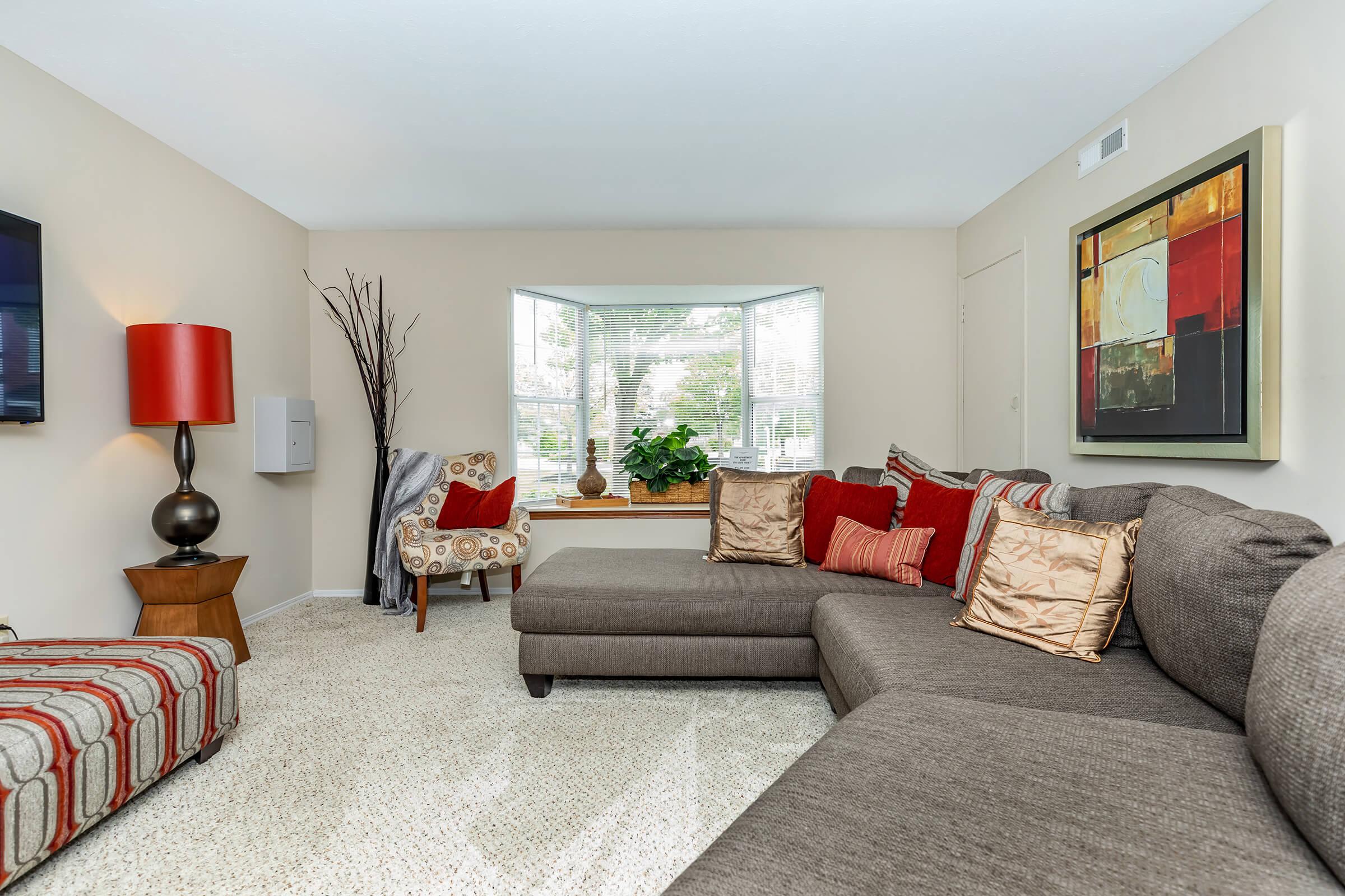 a bedroom with a view of a living room