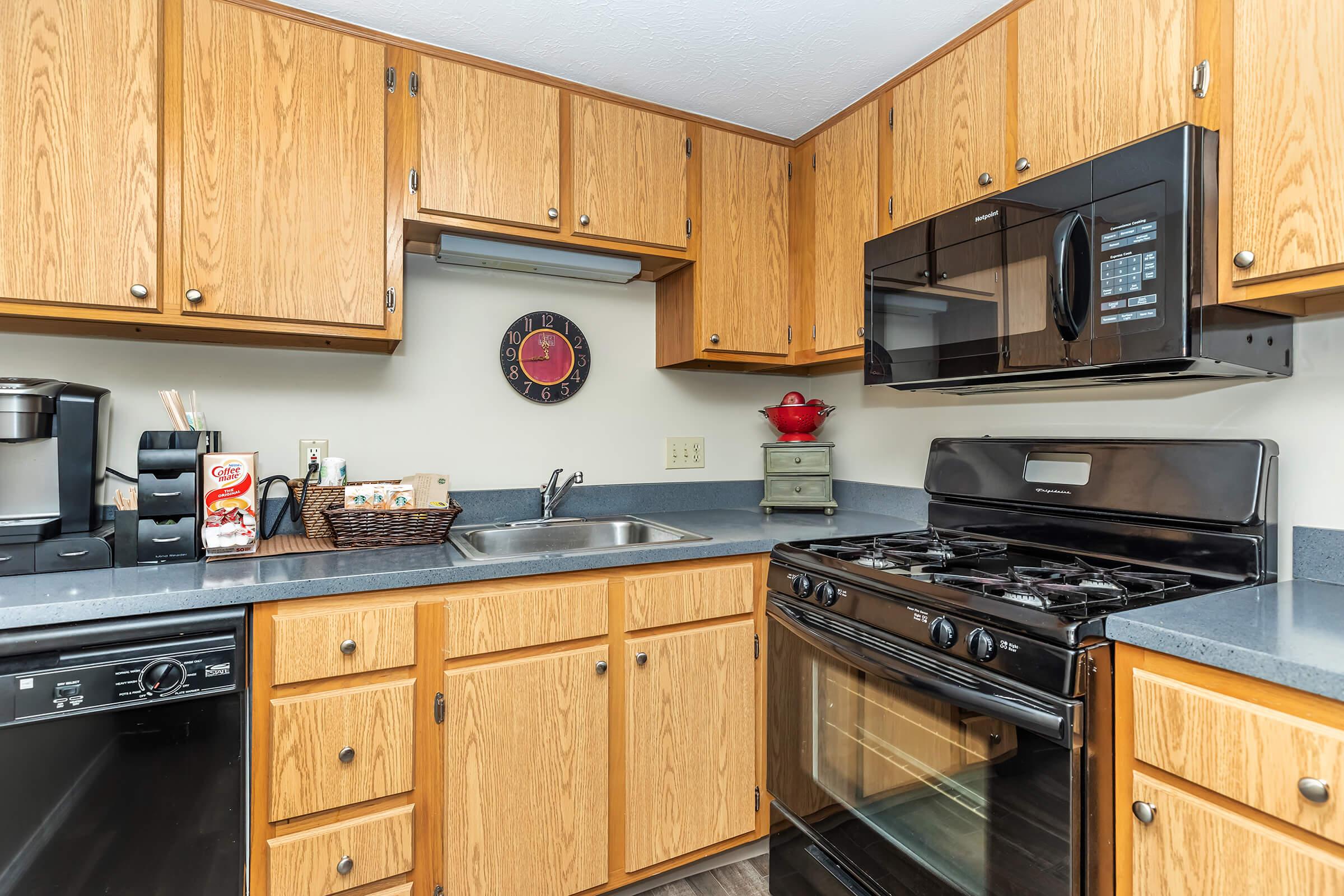 a kitchen with stainless steel appliances and wooden cabinets