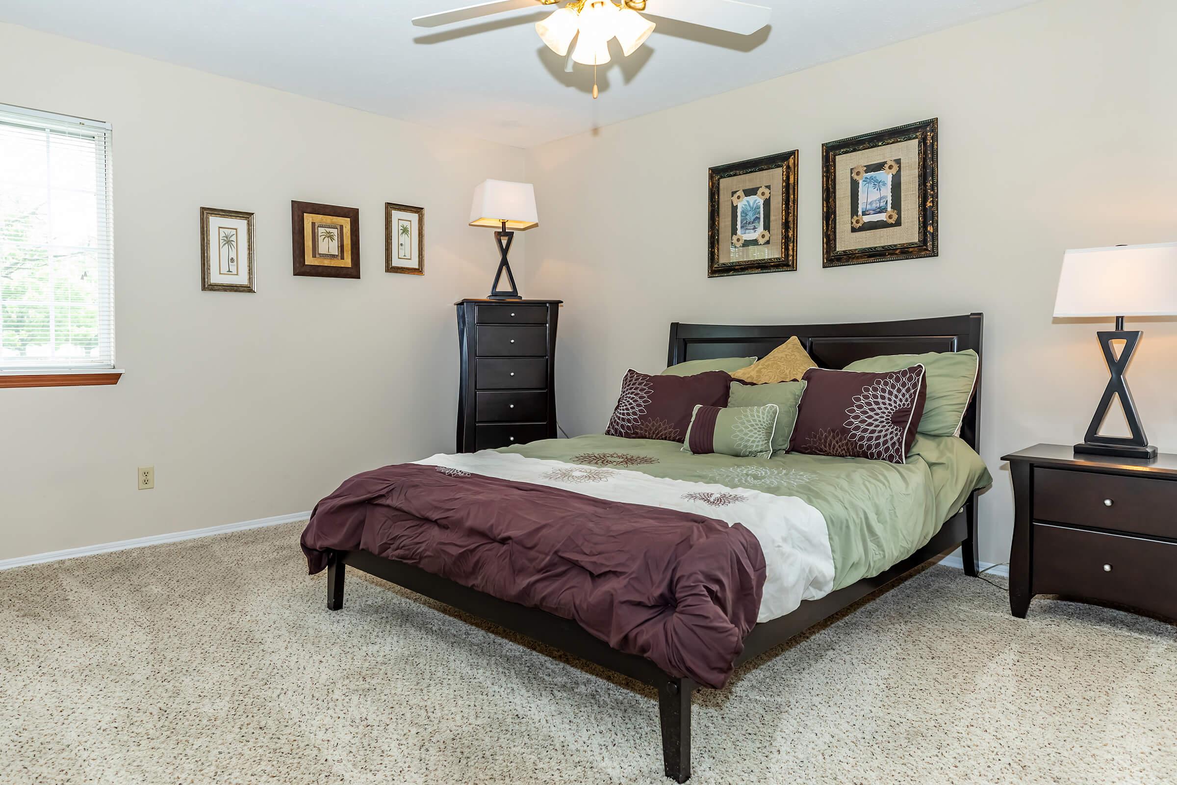 a bedroom with a bed and desk in a room