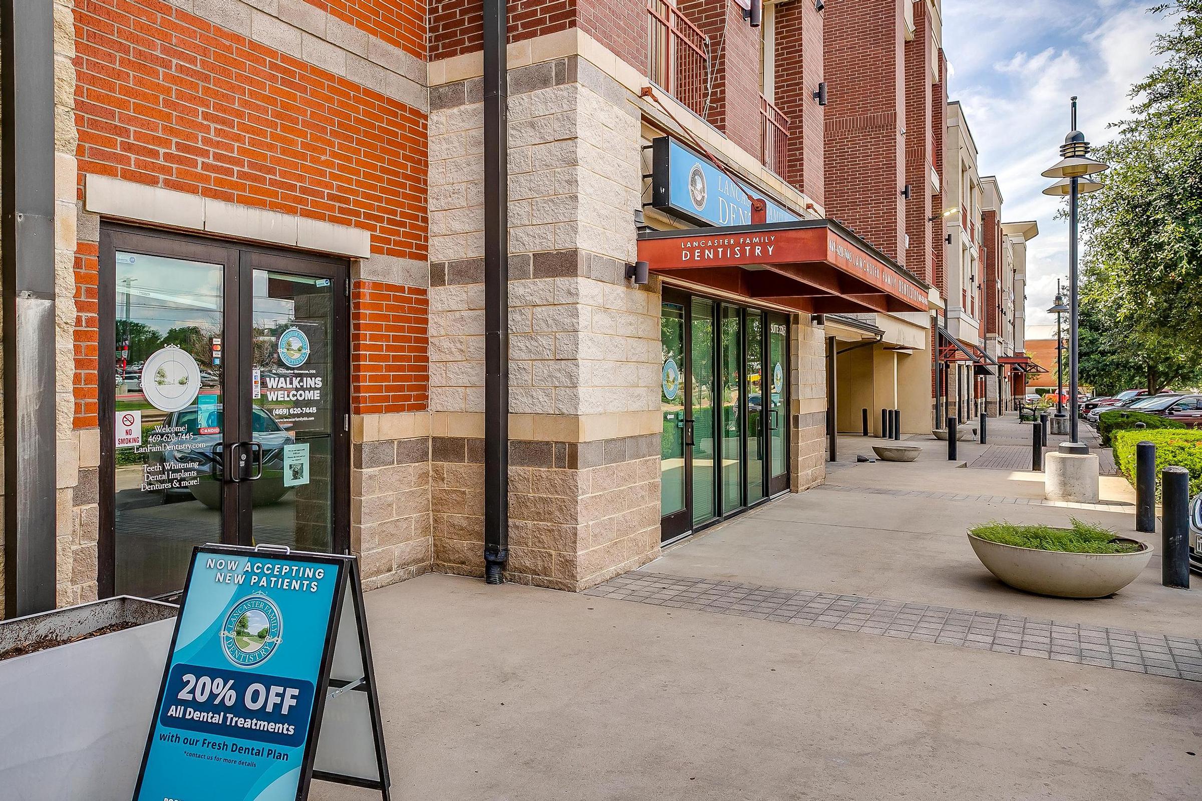 a large brick building with a store on the sidewalk