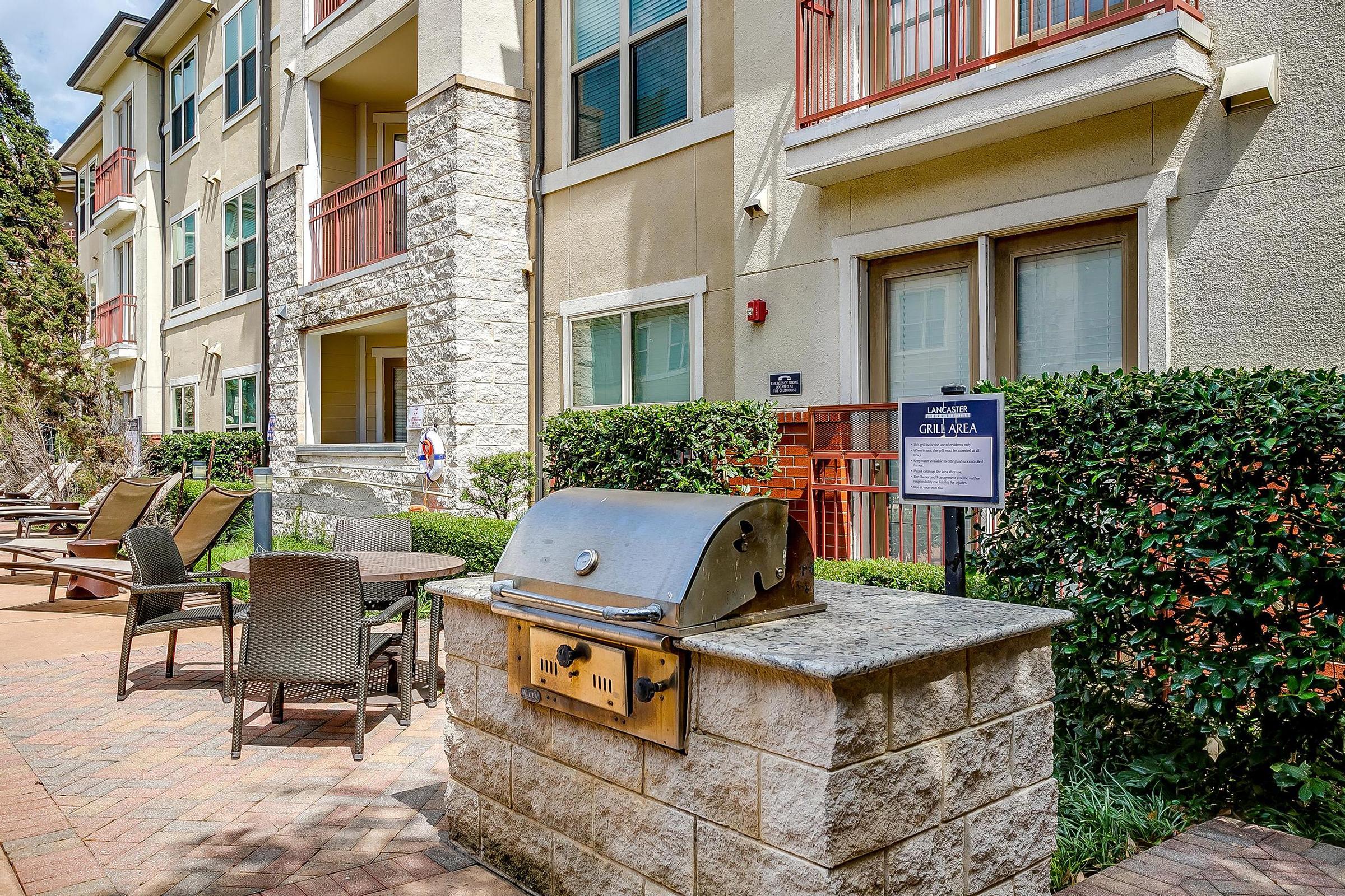 a stone bench sitting in front of a building