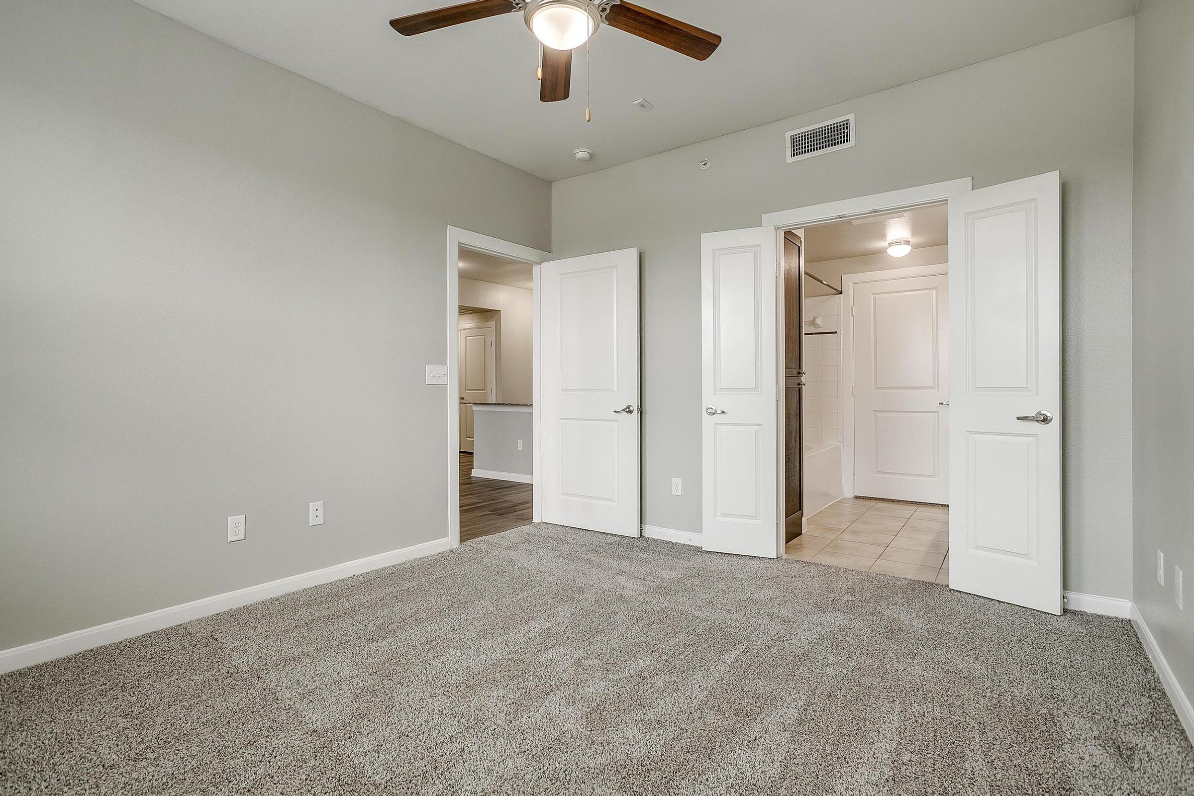 a bedroom with a large mirror