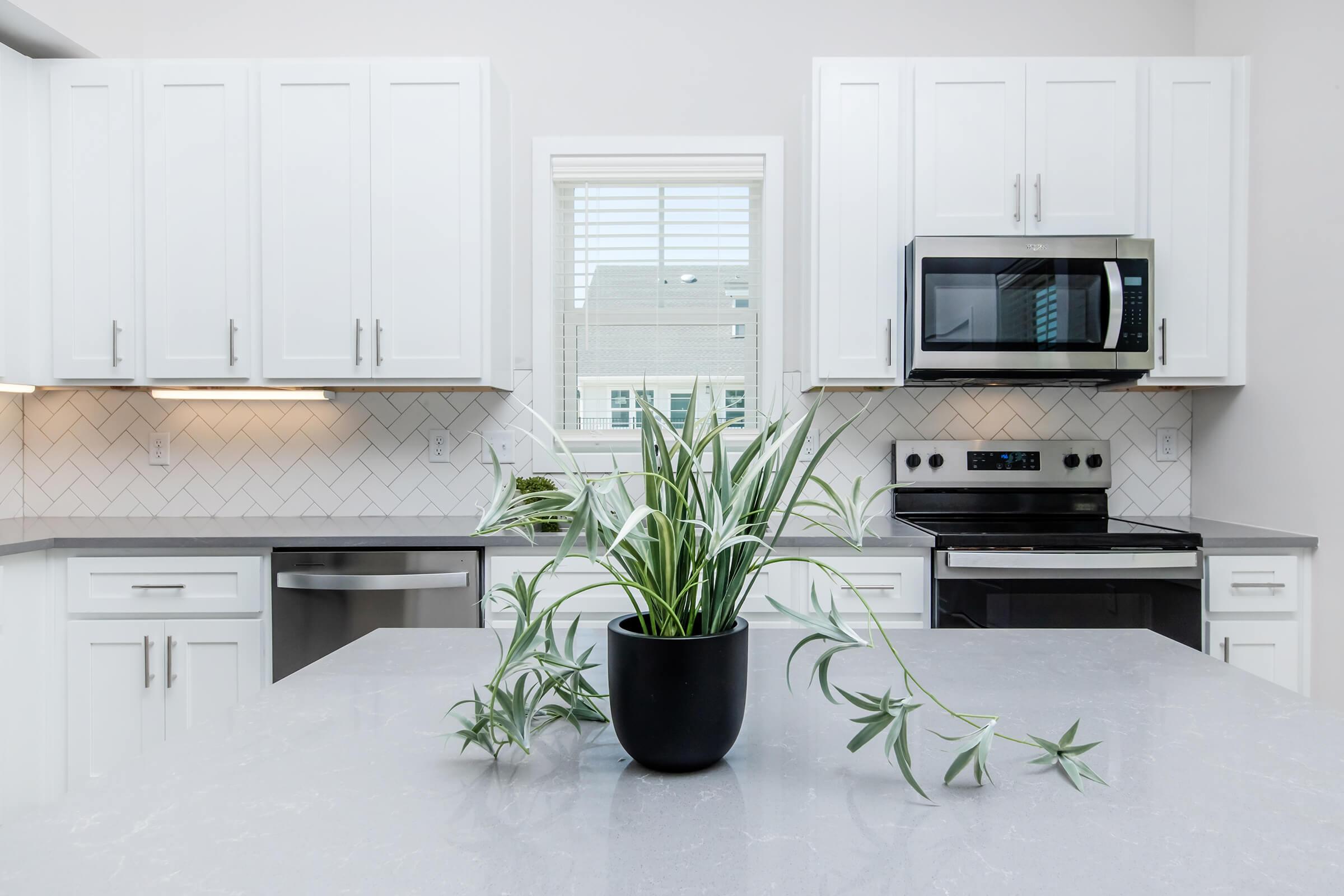 a kitchen with a stove top oven sitting next to a window