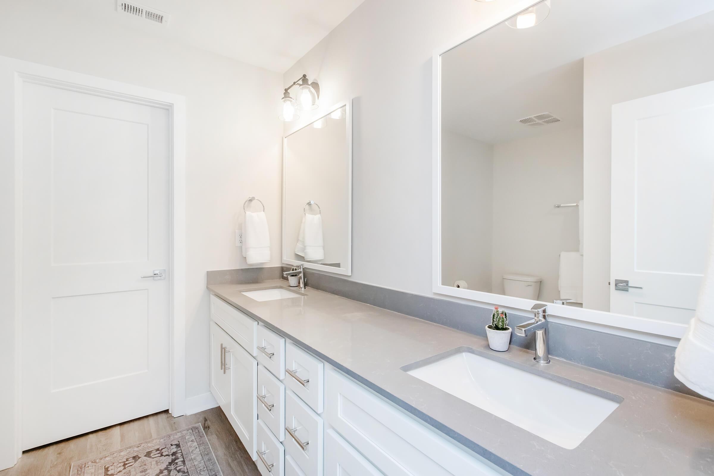 a kitchen with a sink and a mirror