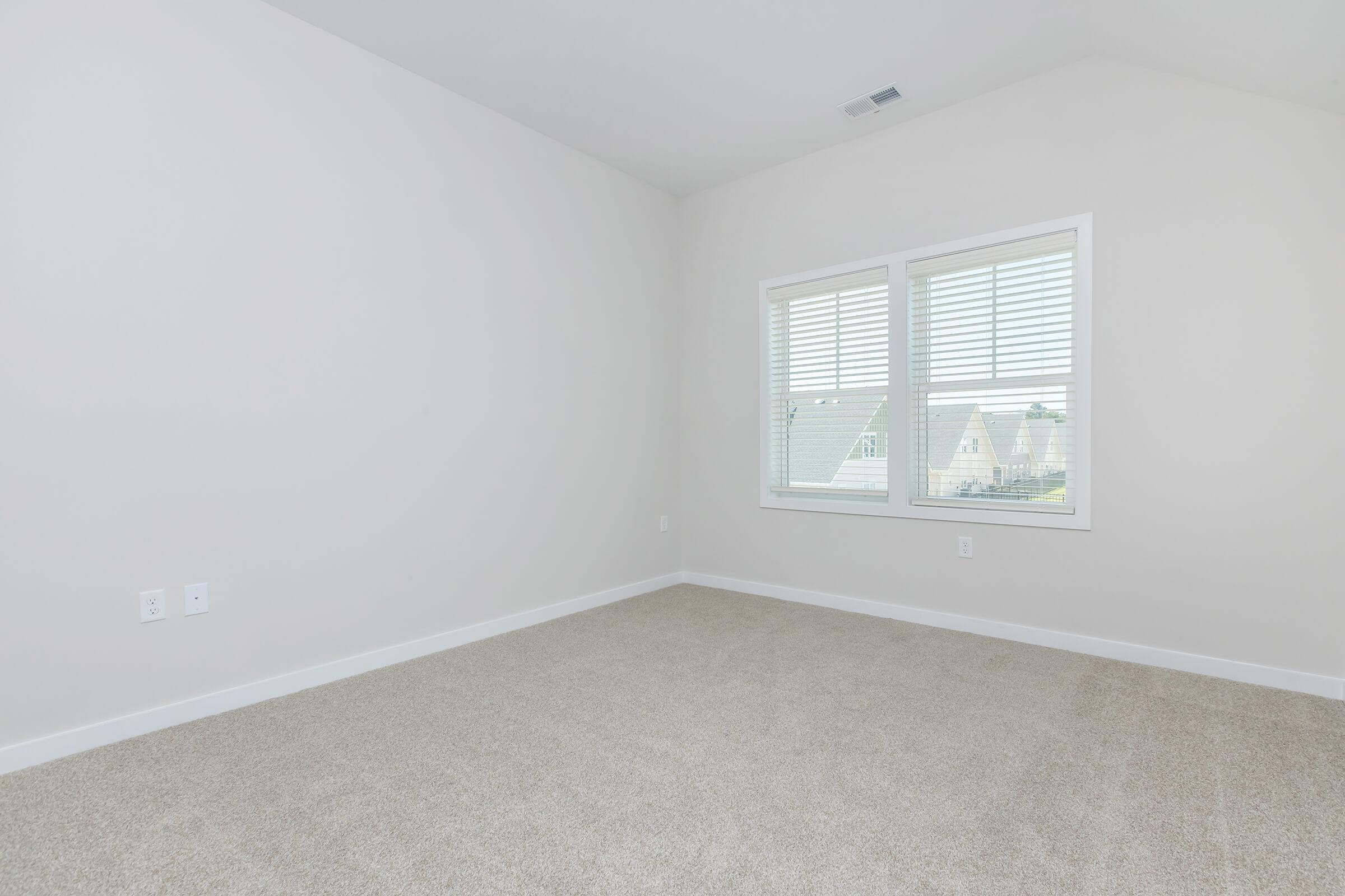 a bedroom with a large window