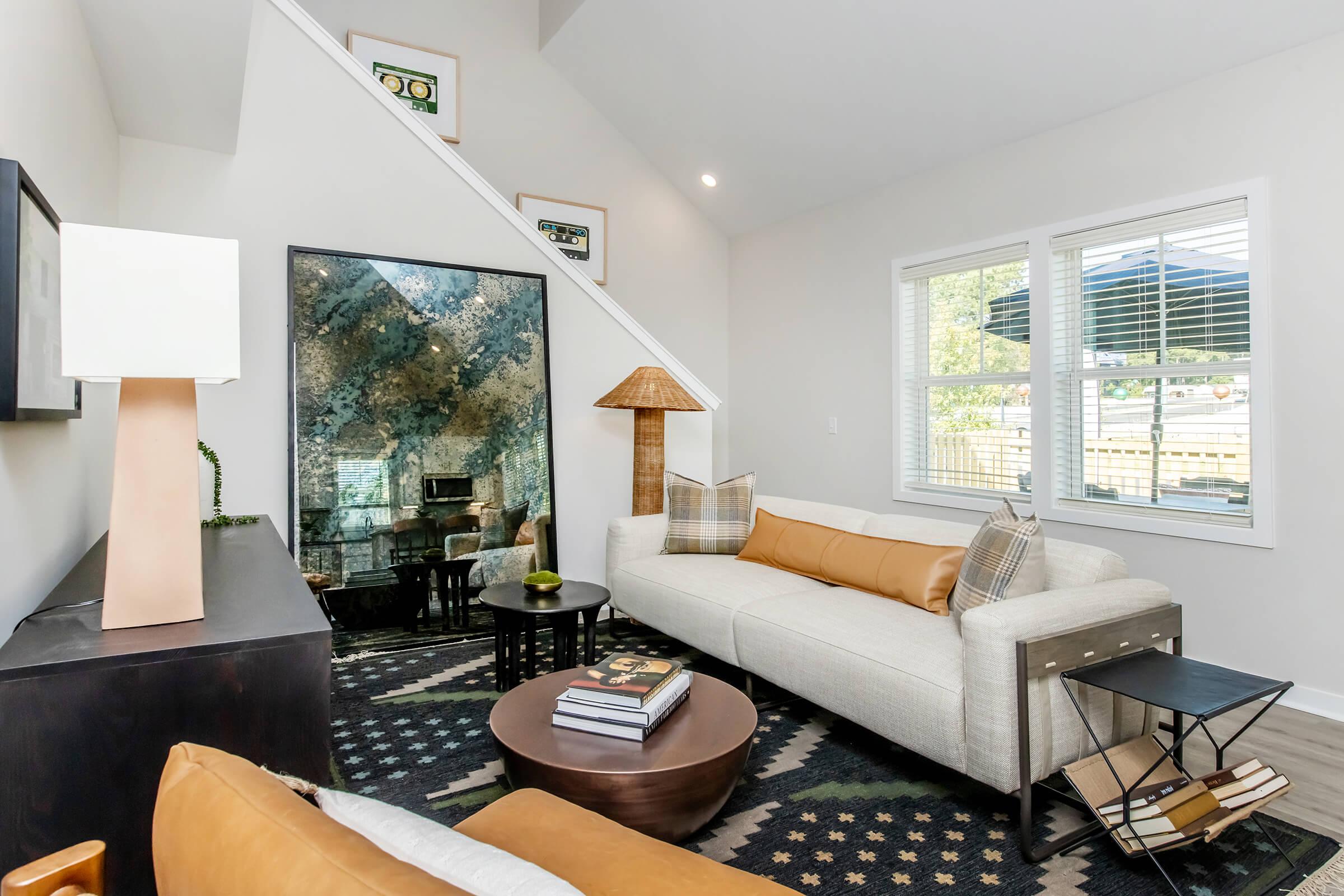 a living room filled with furniture and a large window