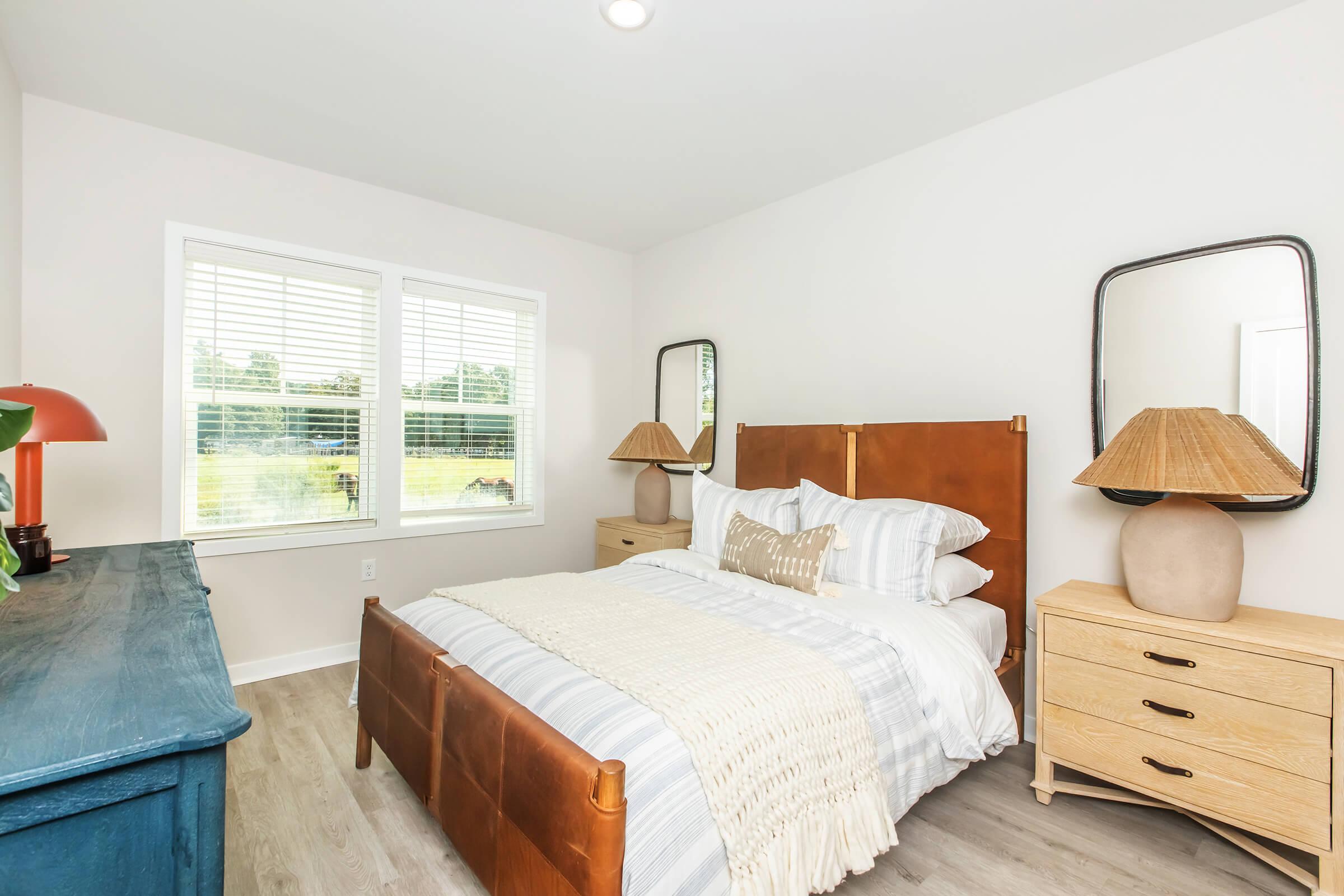 a bedroom with a bed and desk in a room