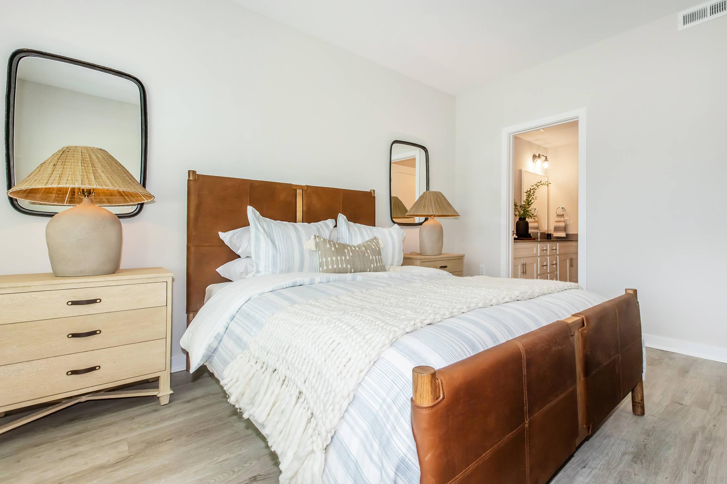 a bedroom with a bed and desk in a room