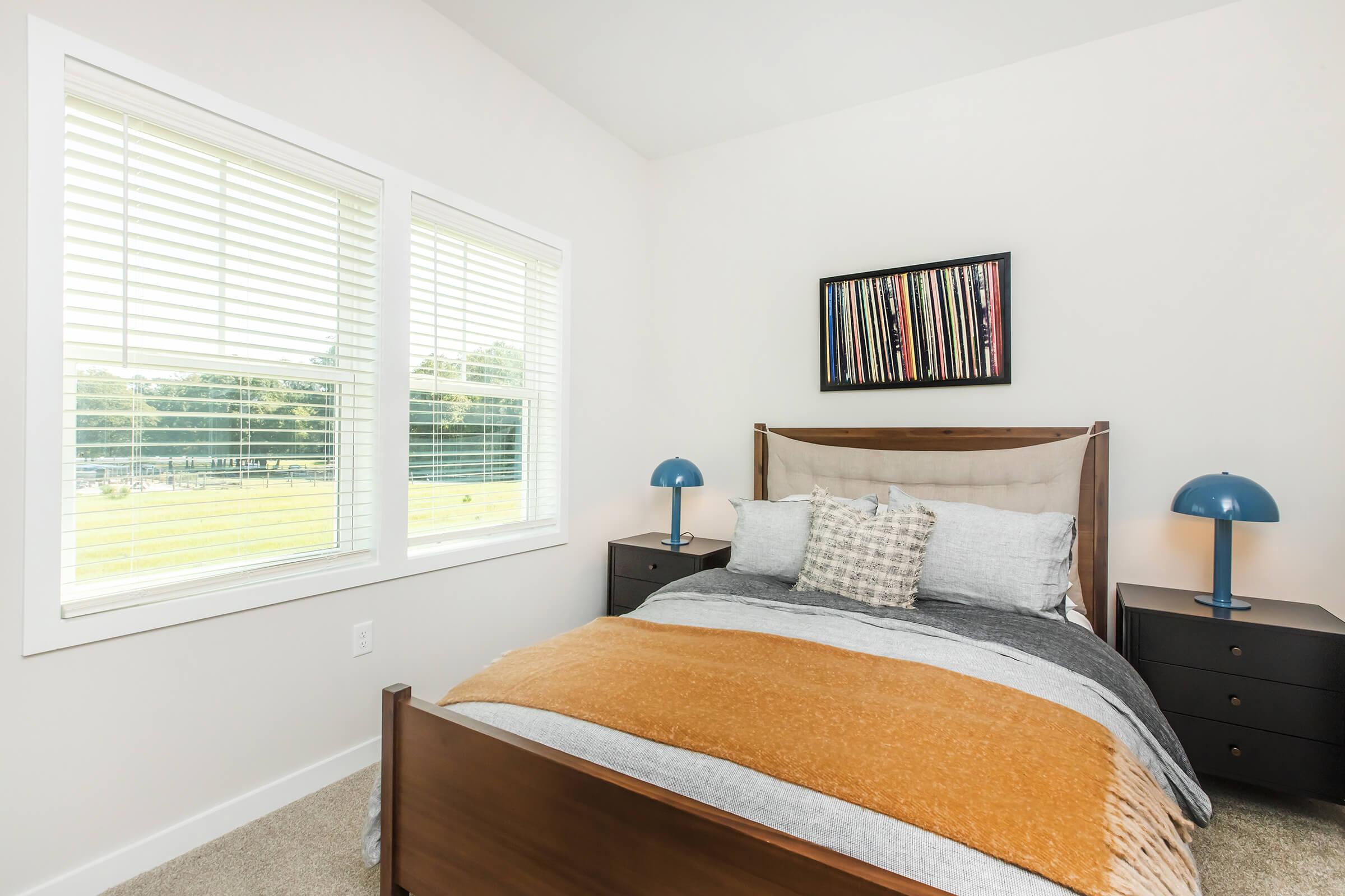 a bedroom with a bed and window in a room