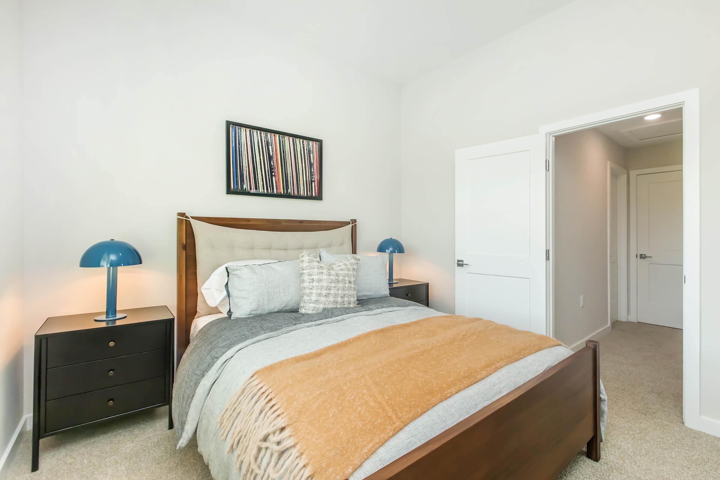 a bedroom with a bed and desk in a small room