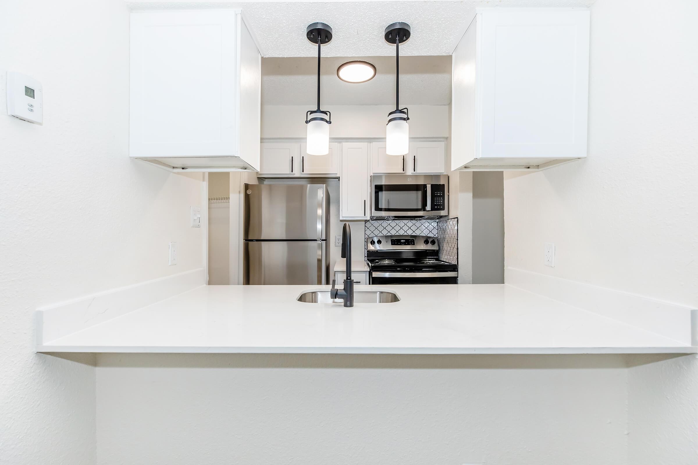 a kitchen with a sink and a refrigerator