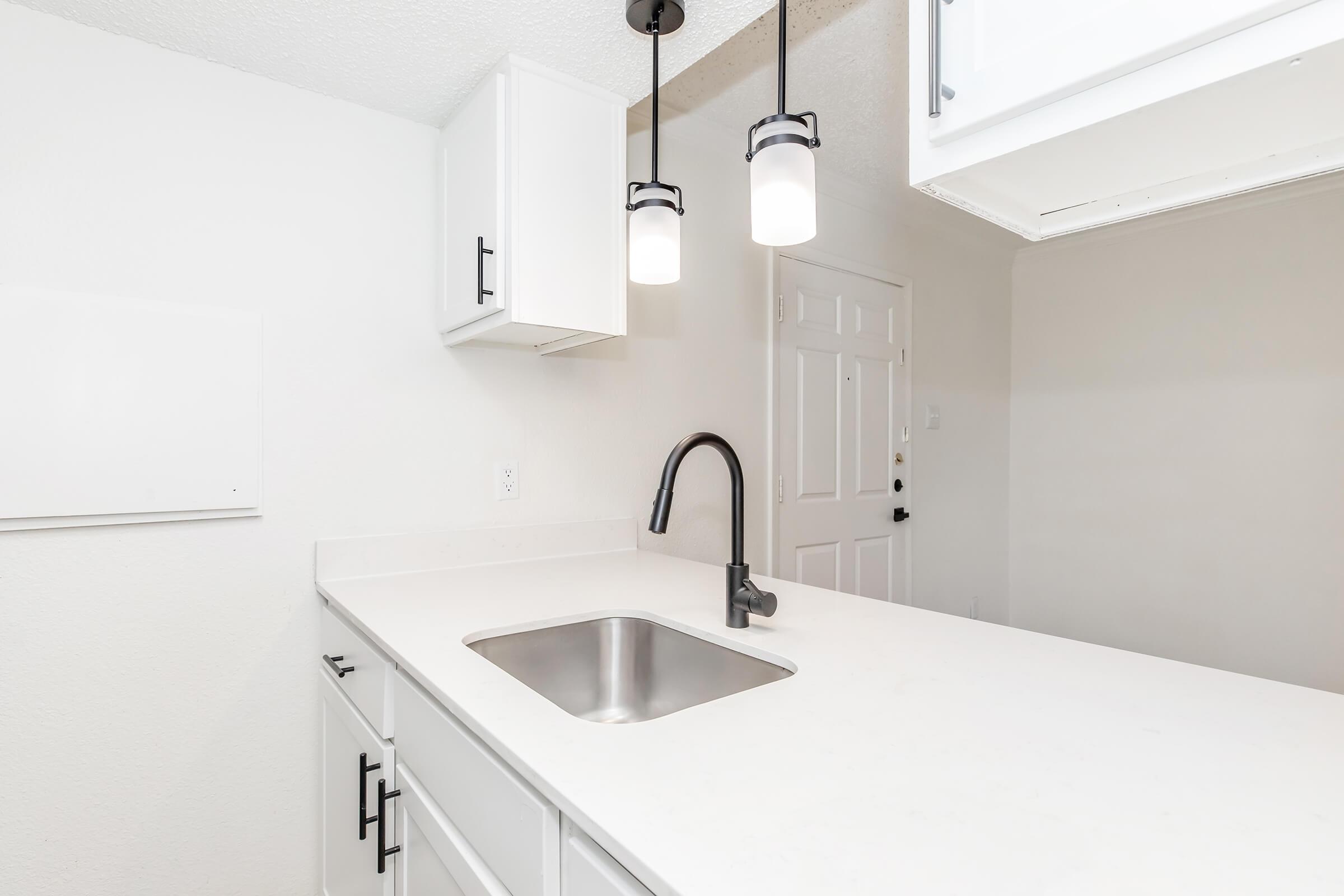 a kitchen with a sink and a mirror