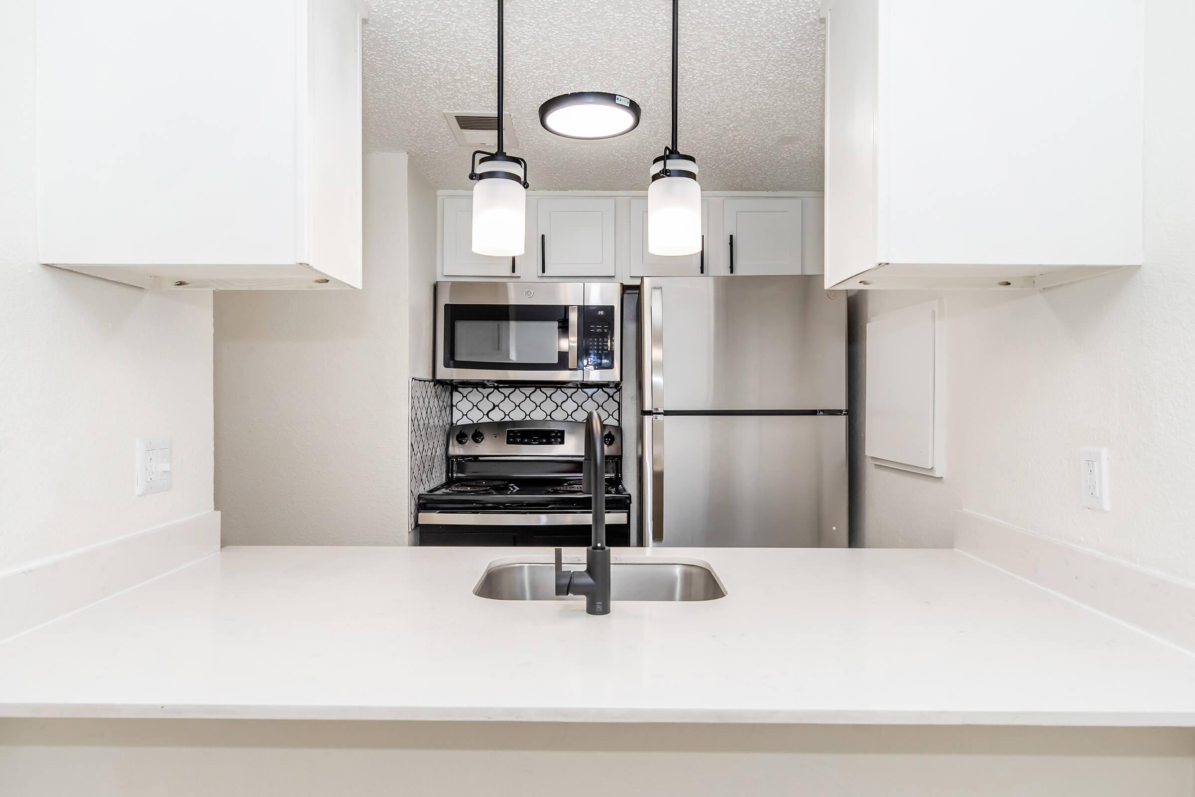 a kitchen with a sink and a microwave